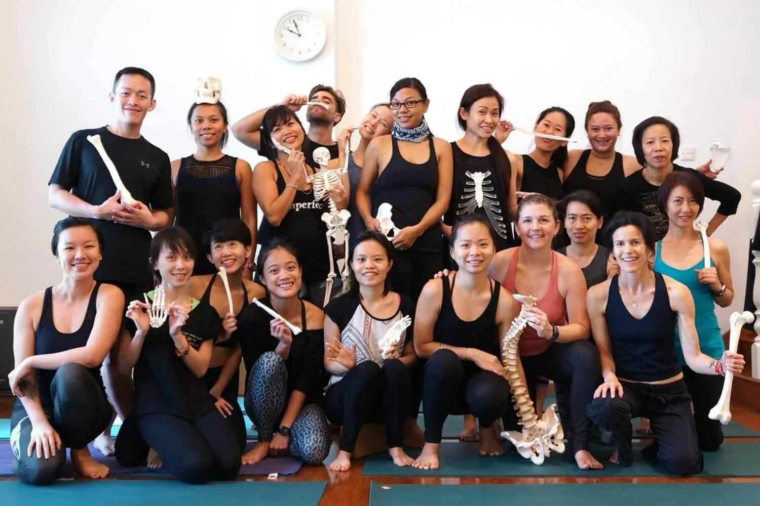 Dr Trish Corley with yoga anatomy training participants holding bones
