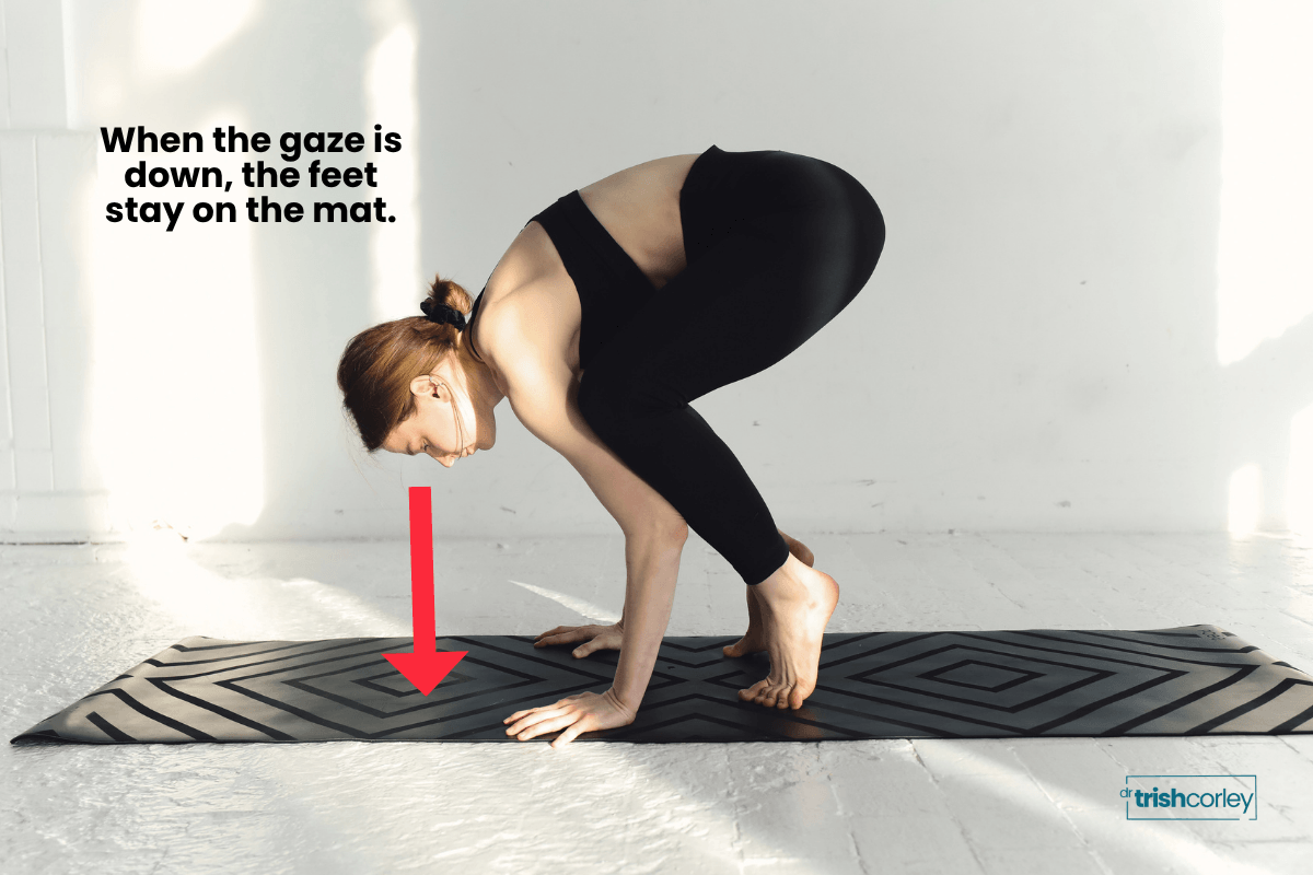 oga student in crow pose with annotation showing how gaze direction affects balance