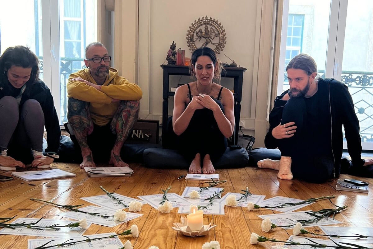 Closing circle at a Rocket Yoga teacher training in Lisbon with Lita Sattva, certificates and flowers arranged on the floor
