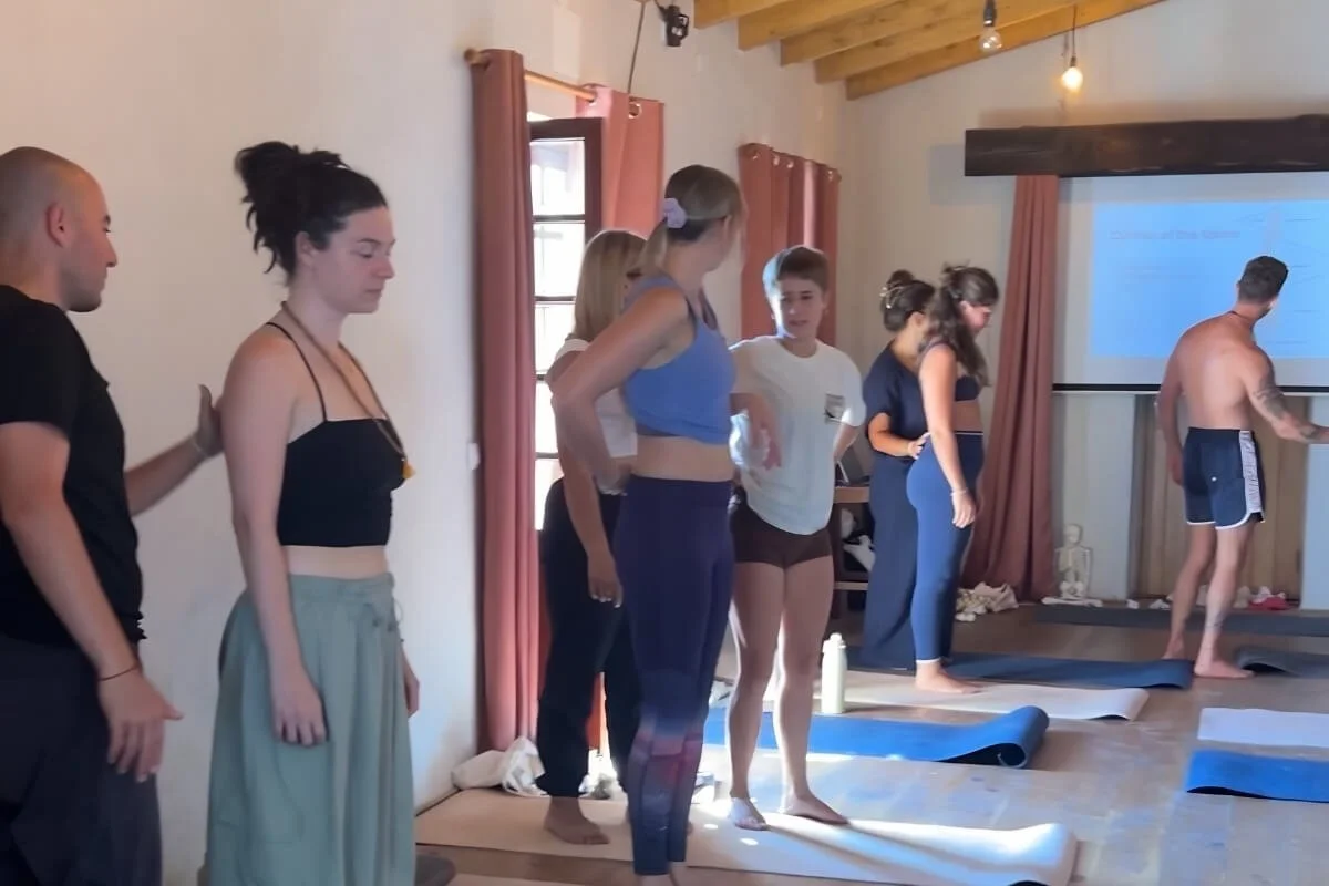 Yoga teachers learning anatomy with Dr. Trish Corley at Ancestral Academy's teacher training in Aljezur, Portugal