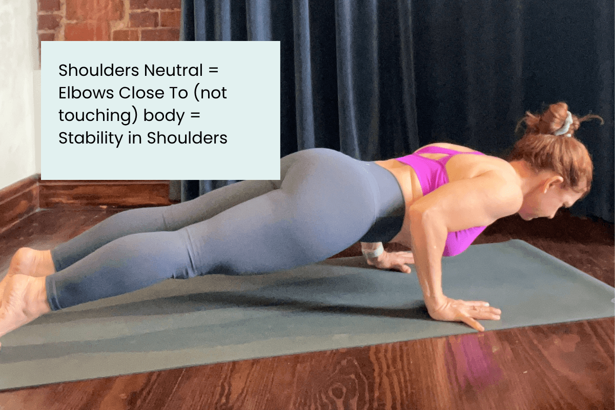 Dr. Trish Corley in chaturanga demonstrating neutral shoulder position with elbows naturally close to sides