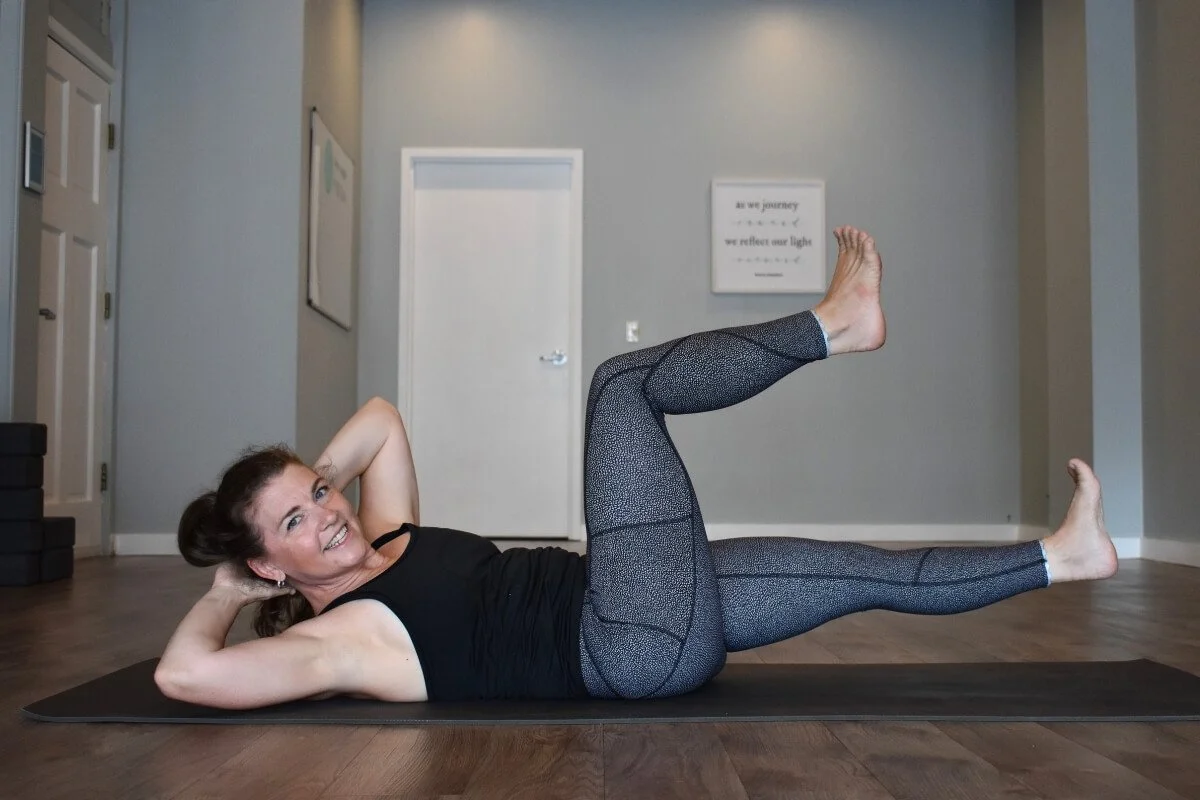 rish Corley, Yoga teacher performing leg lifts on her mat, a movement that can cause hip tendons to snap