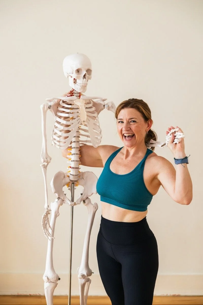 Dr. Trish Corley yoga anatomy expert holding anatomical model