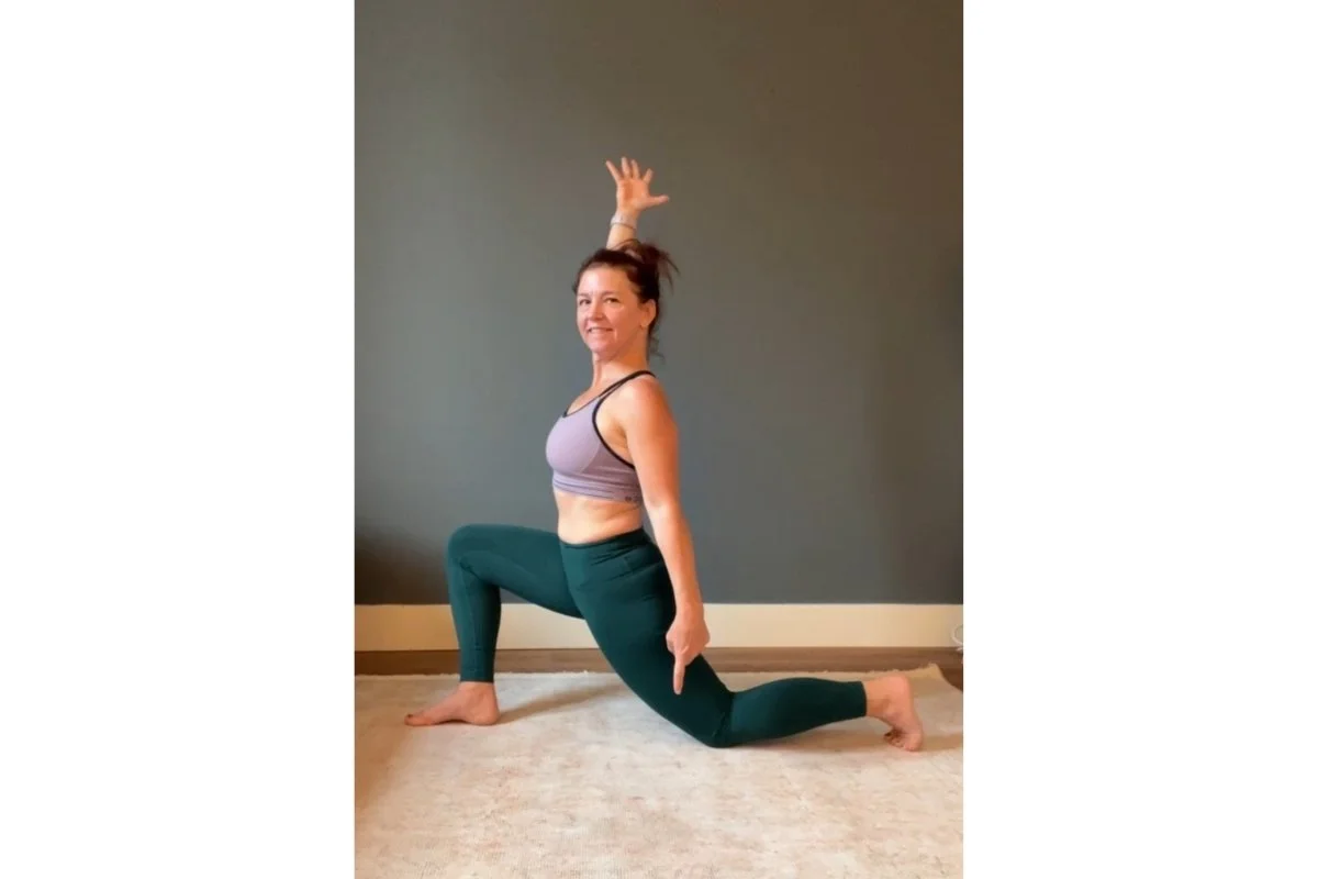 Trish Corley in a low lunge with back knee down, demonstrating a yoga modification that widens the base of support