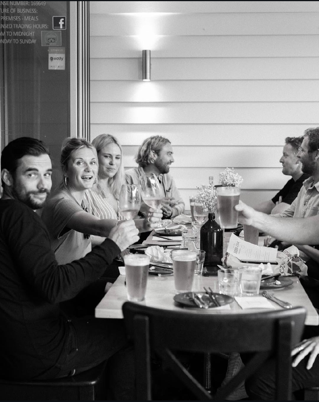 6 guests enjoying drinks and food on the patio at Corbins