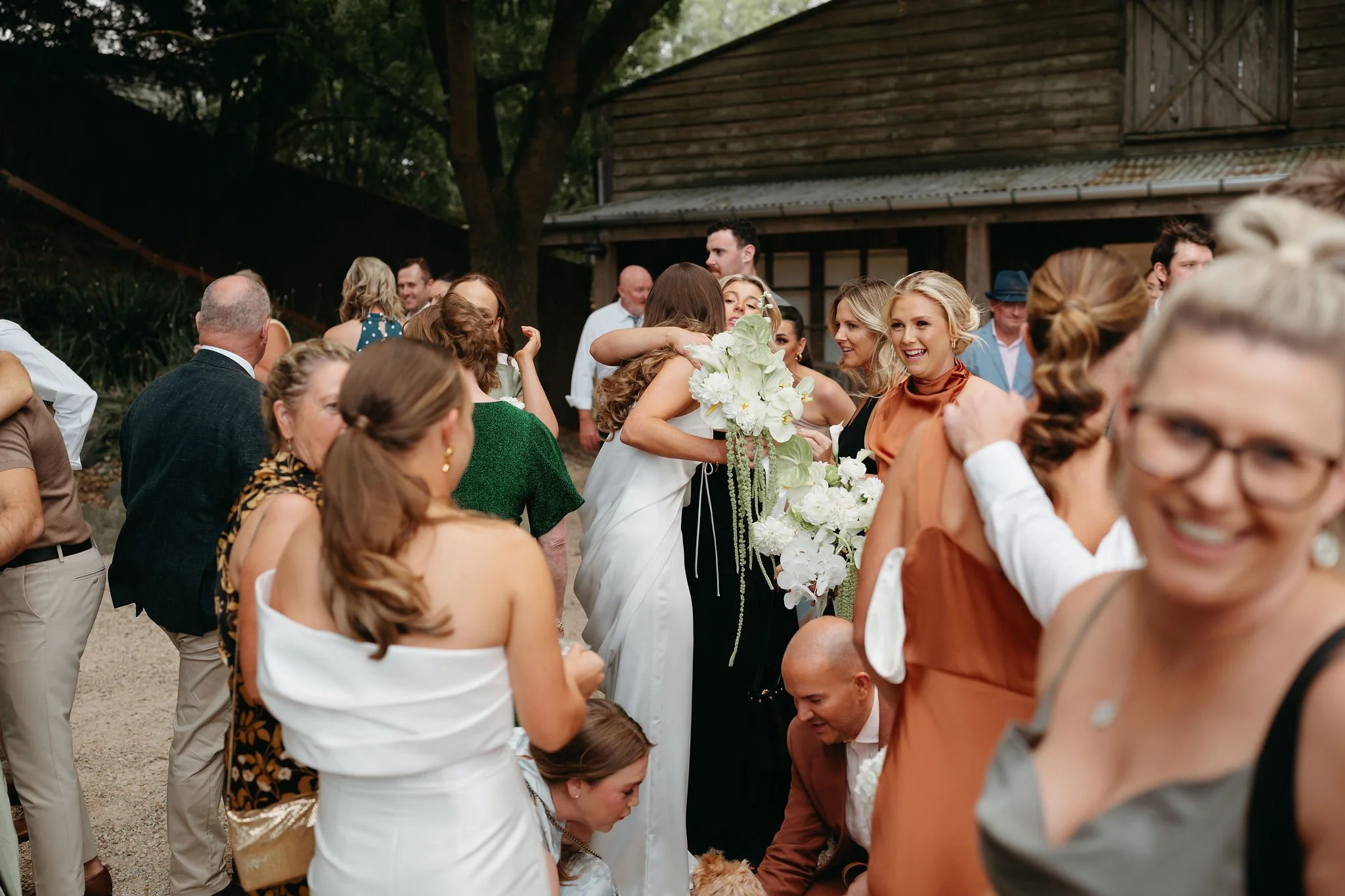 soph-meg-the-farm-yarra-valley-wedding-reception-hugs.jpg