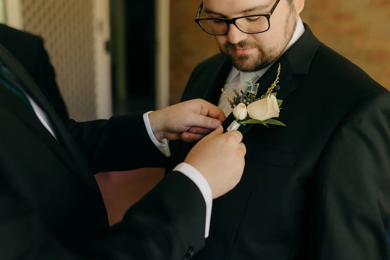 nathan-rachael-collingwood-childrens-farm-wedding-celebrant-button-hole.jpg