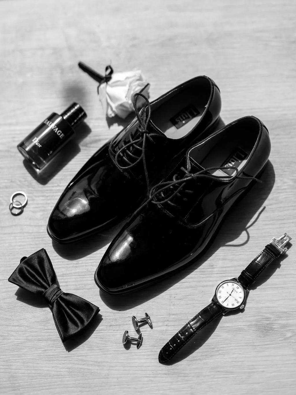 Black and white detail shot of wedding rings and stationery at Butler Lane