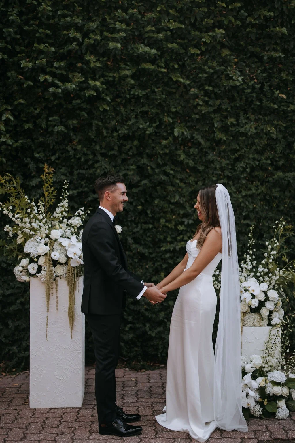 Couple holding hands during Butler Lane wedding vows