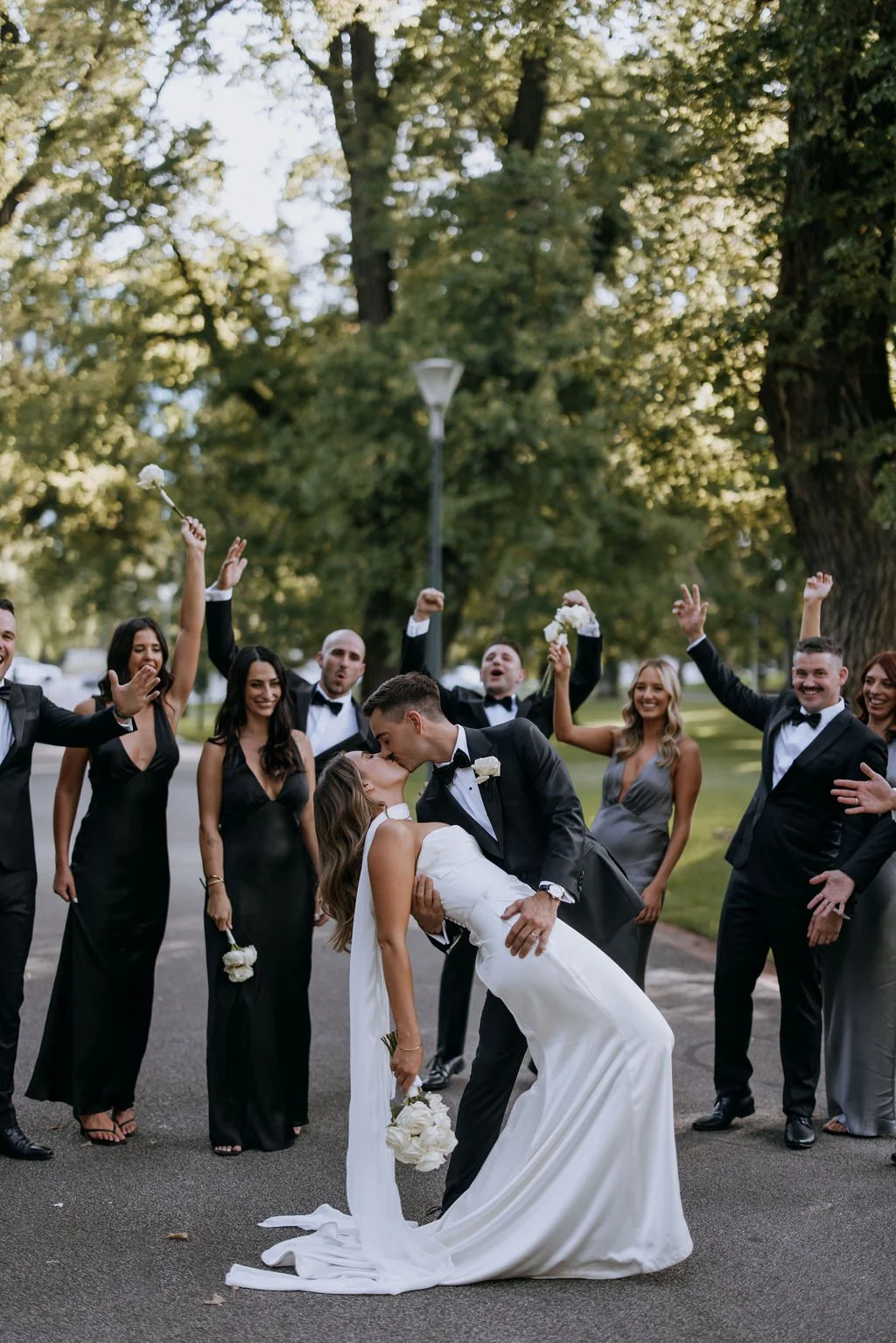 Groom dipping bride for a kiss at Fitzroy Gardens