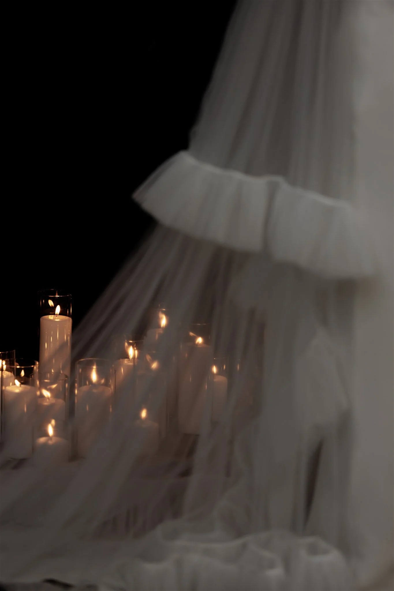 The candles and veil added to their romantic setting