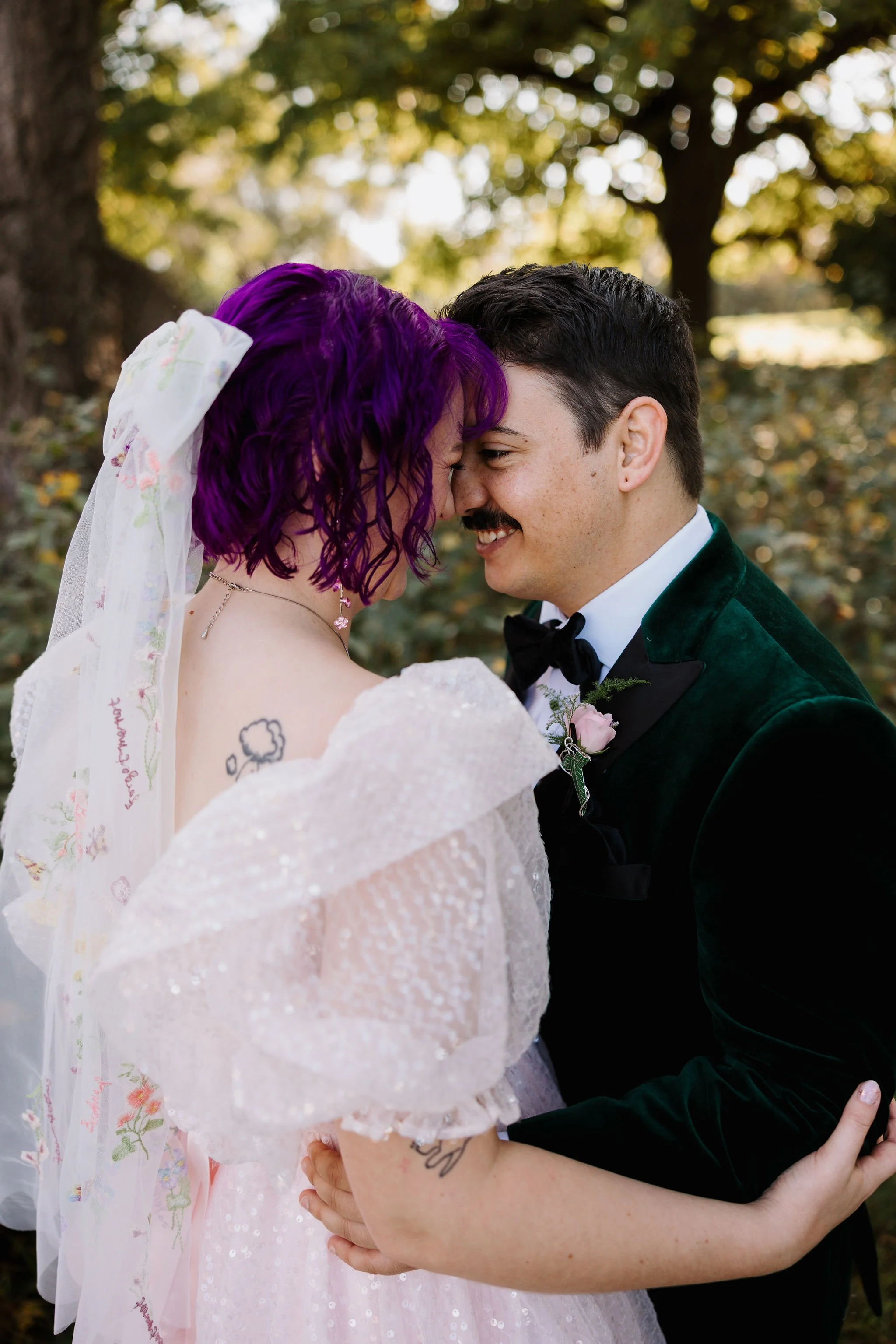 Ducky's tattoo just peaking out as they embrace their spouse
