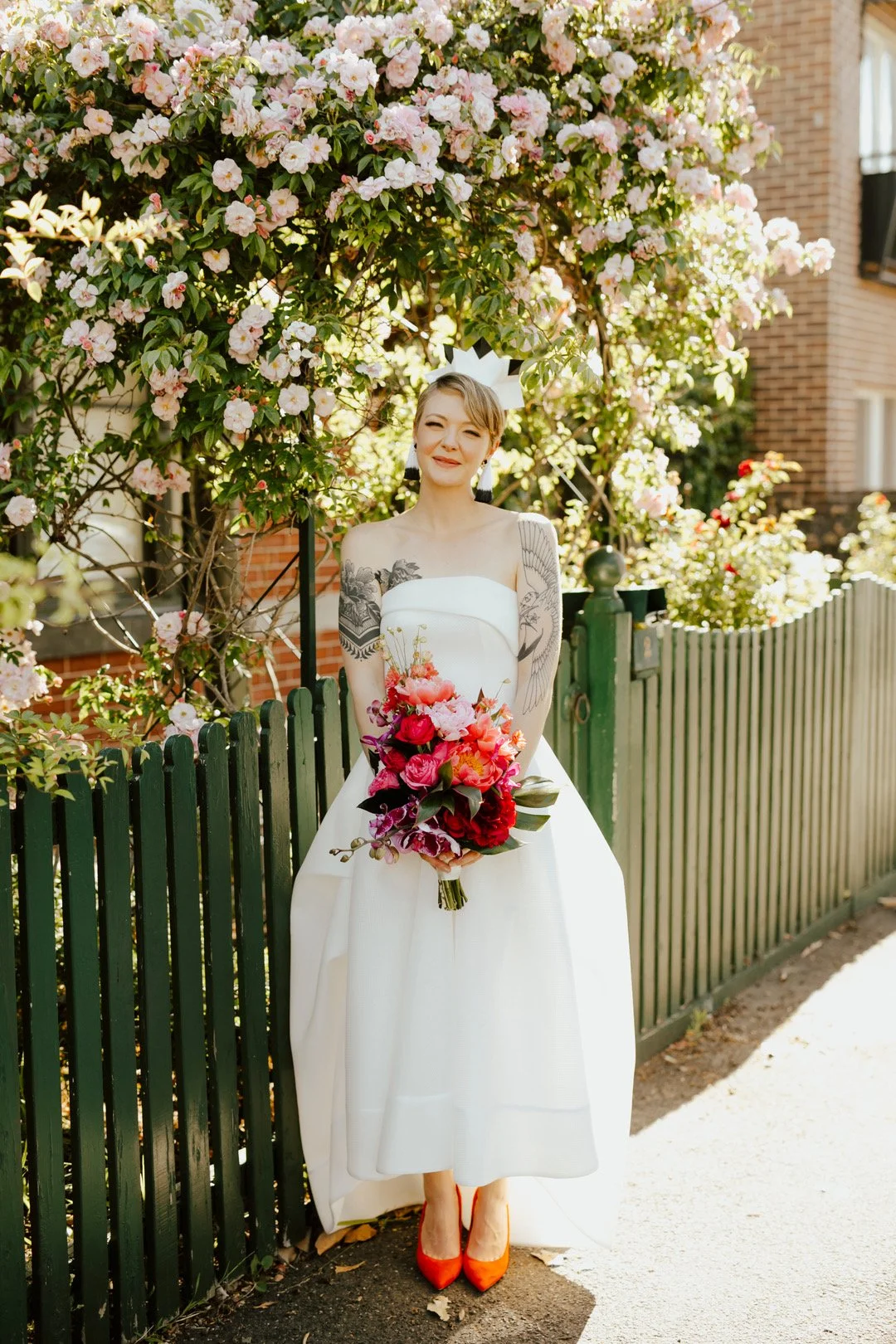 Nanette looking glorious in her wedding dress showing off her tattoos