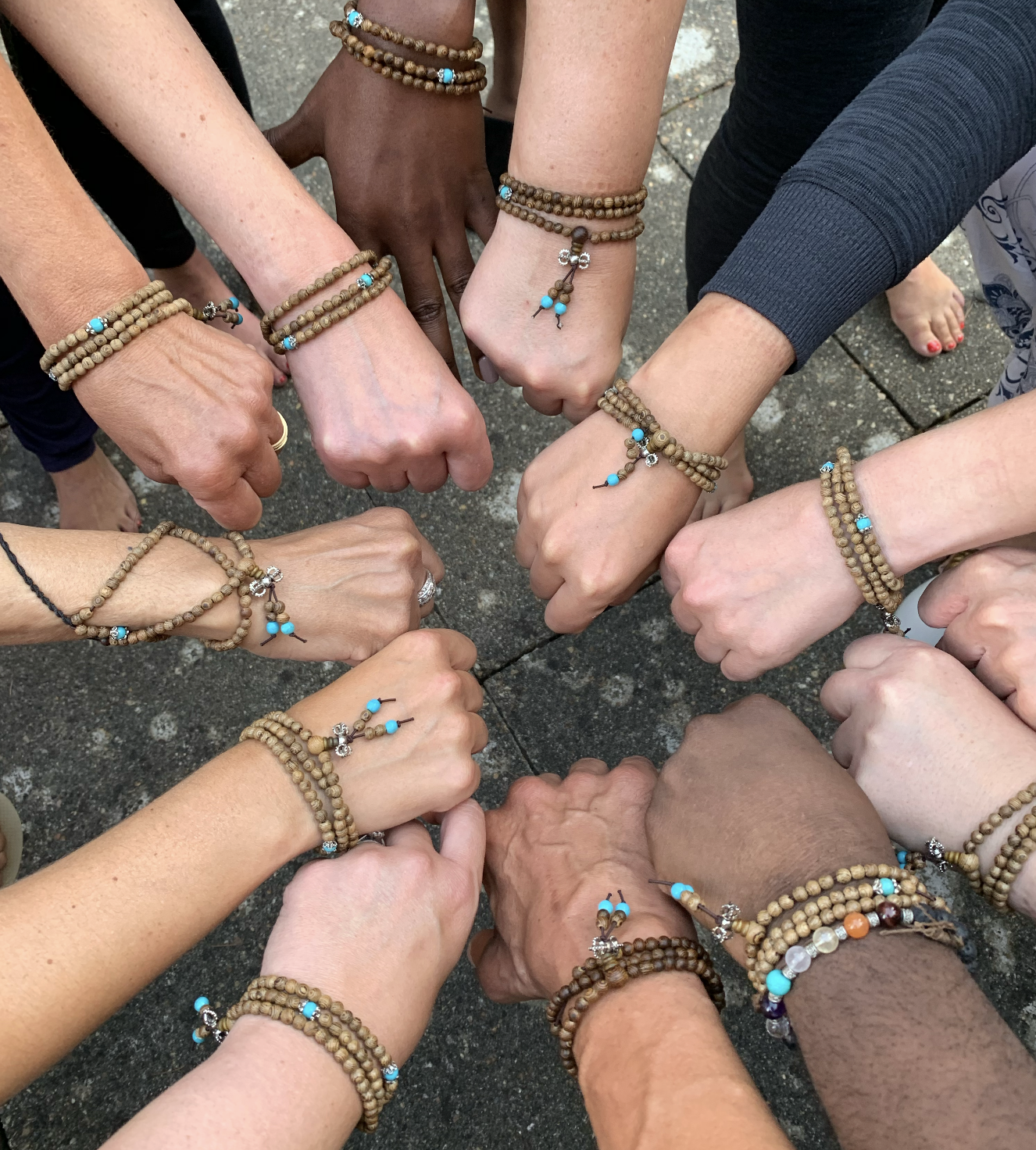 Many hands of a Yoga community coming together as one at YinWave