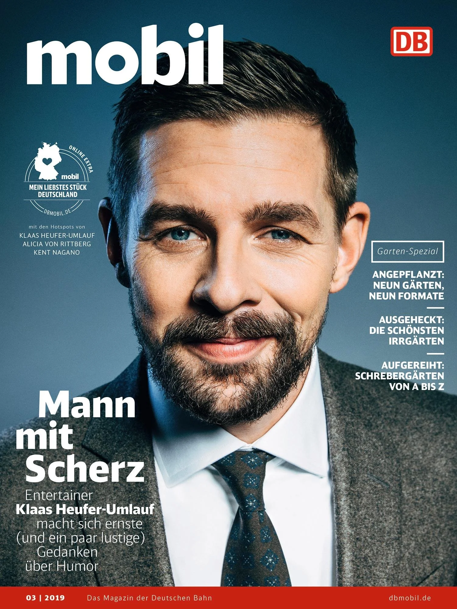 Magazine cover featuring a man with dark hair and a beard, wearing a suit and tie, smiling at the camera. The magazine is titled "mobil" with the Deutsche Bahn logo in the top right corner.