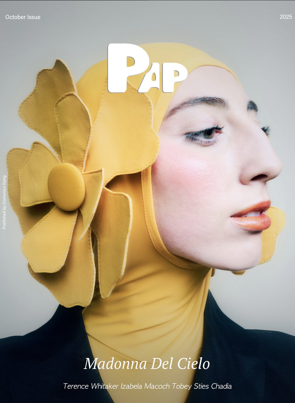 Cover of PAPER magazine featuring Madonna Del Cielo, wearing a yellow headscarf with large yellow flower design, facing right, with makeup and black clothing.