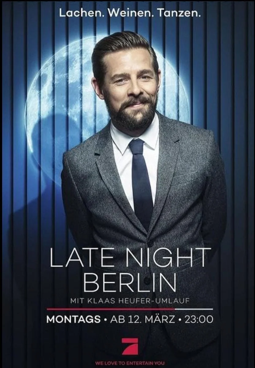 Promotional poster for an event called 'Late Night Berlin' featuring a man in a suit with a moon in the background, with text in German and English advertising the show and its details.