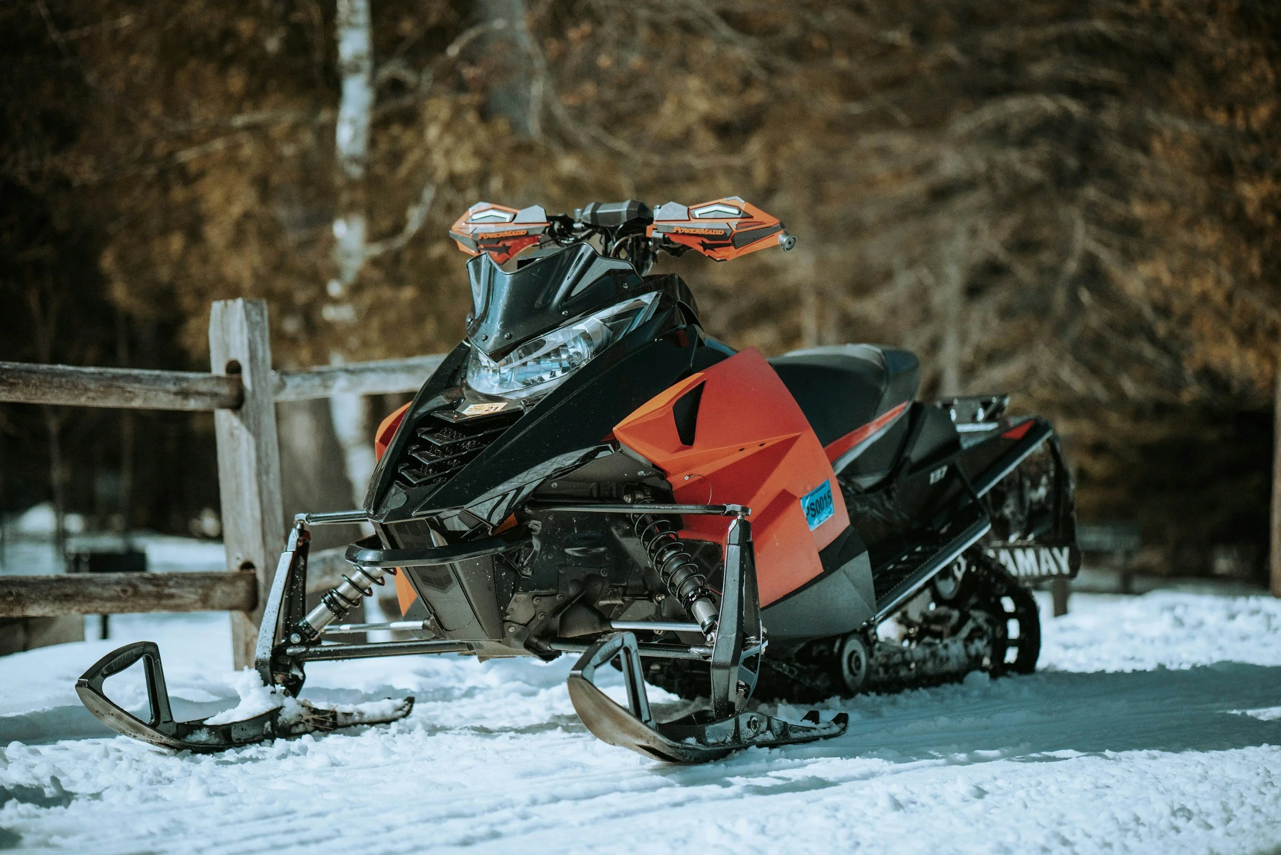 Orange Yamaha snowmobile outside