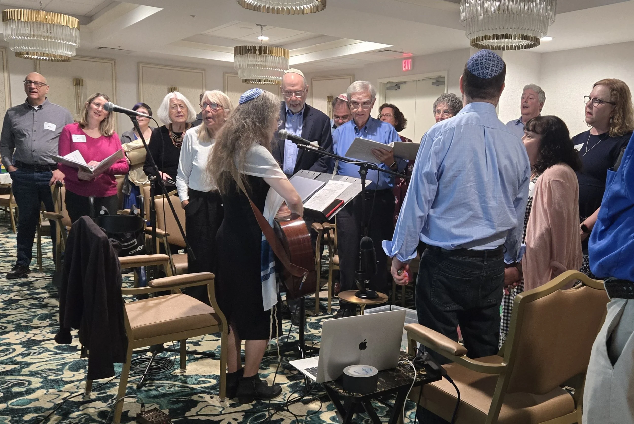 Cantor Abby Gostein leading the Kol Shira congregation in prayer and musical song during the Torah dedication service in Austin.