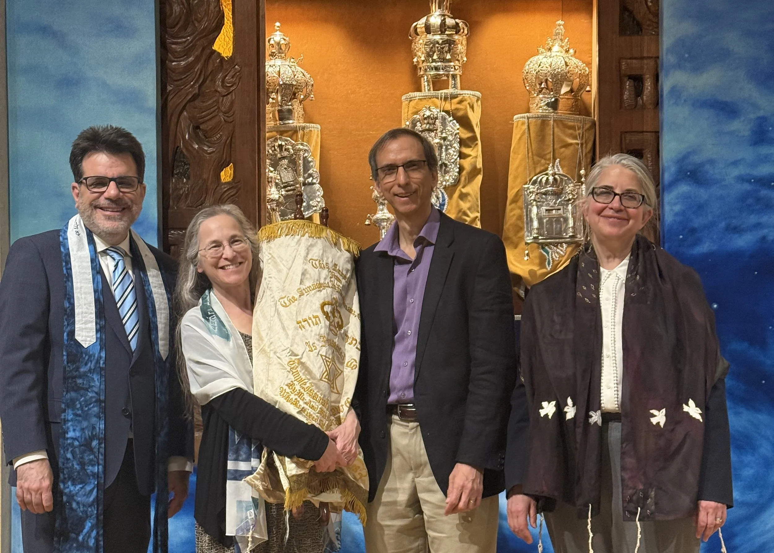 Rabbi Mark Kaiserman and Cantor Emily Wigod Pincus of Reform Temple of Forest Hills present a donated Sefer Torah scroll to Cantor Abby Gostein and Michael Gostein for the Kol Shira Reform Jewish community in Austin.
