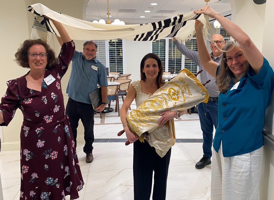 Members of Kol Shira joyfully carry the Sefer Torah into the dedication service led by Cantor Abby Gostein, marking the first reading of this Torah scroll in Austin, Texas.