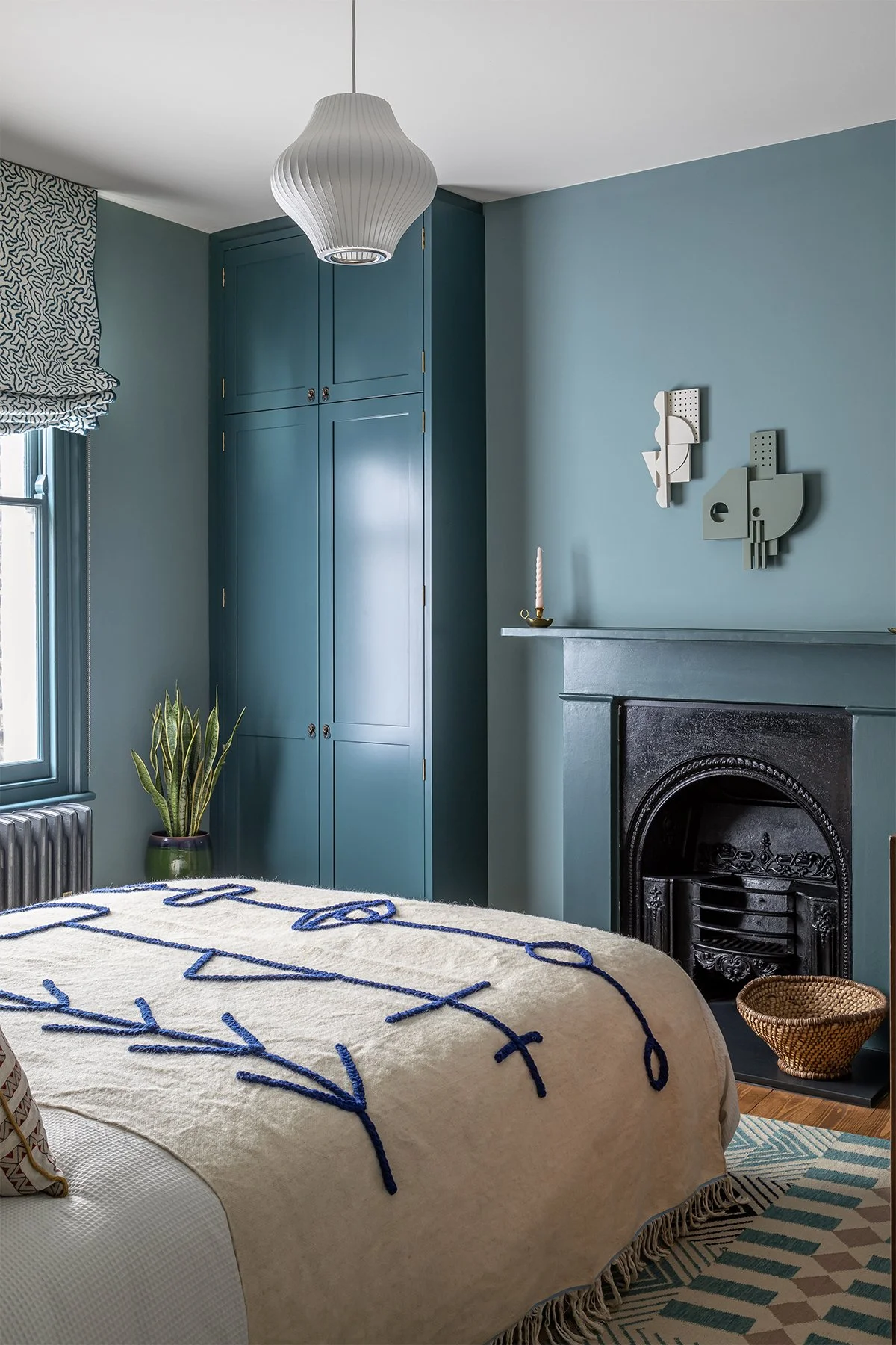 Blue_bedroom_with_cream_blanket_and_patterned_rug.jpg