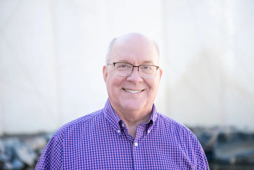 Man with purple shirt and glasses - Mike Weaver