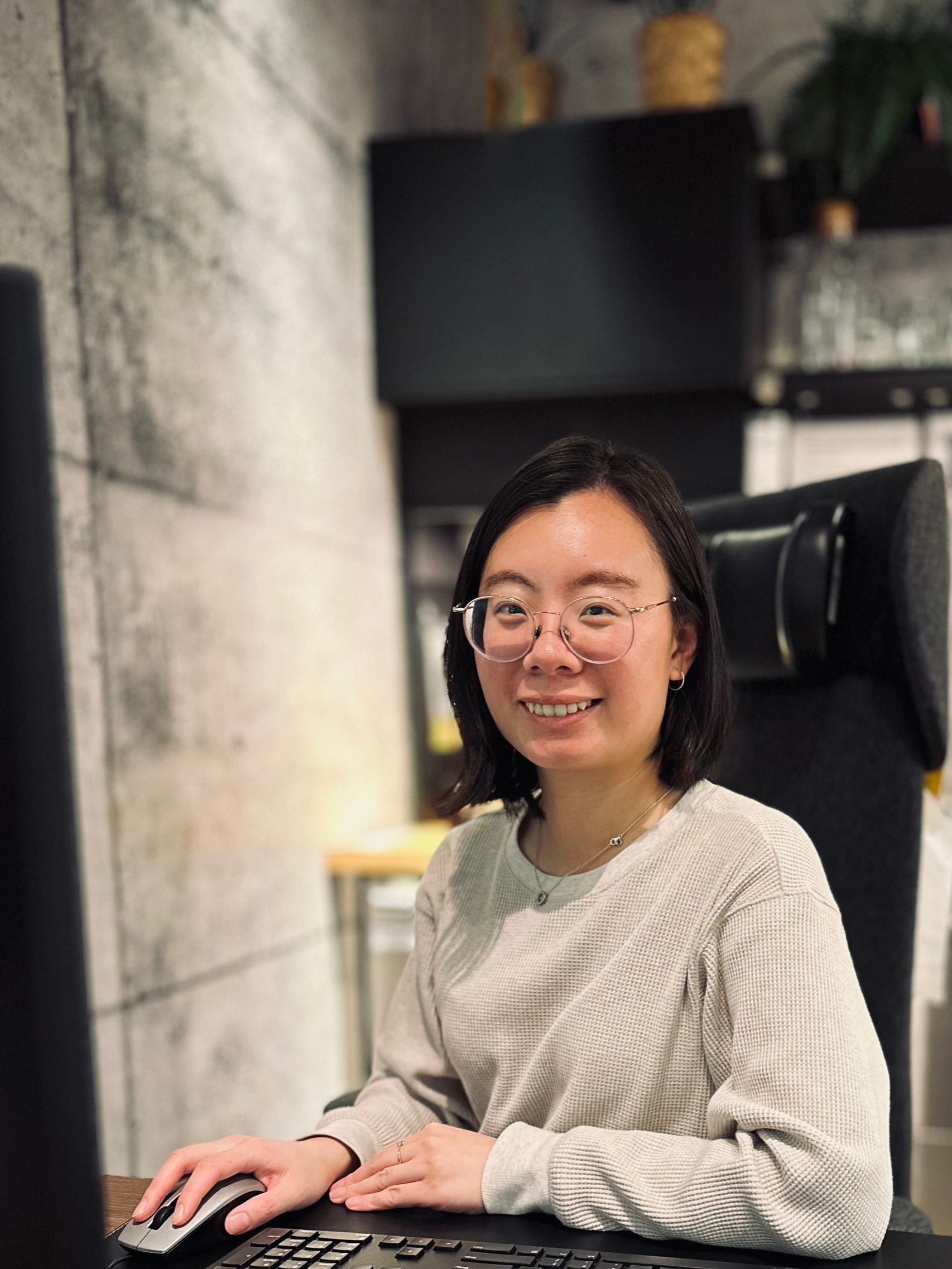Tara Xu, Social Worker/therapist smiling in her workspace for virtual counselling