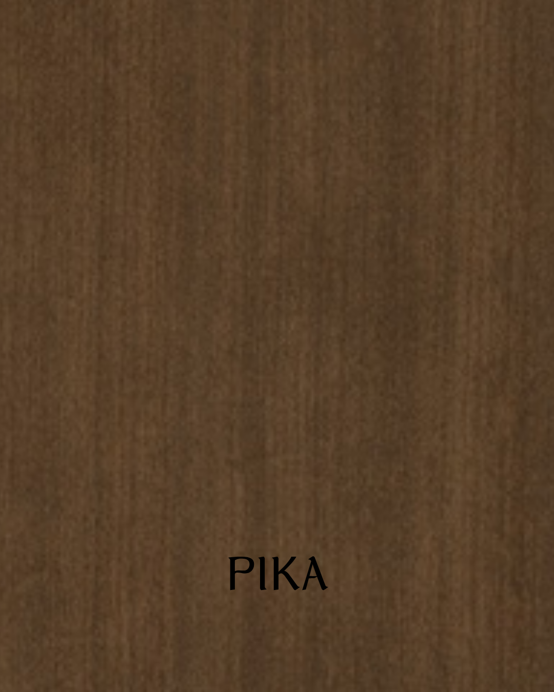 Close-up of a wooden surface with the word 'PIKA' written on it.