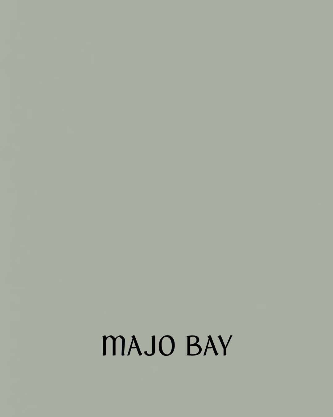 Cover of a book titled "Majo Bay" with a plain, muted green background.