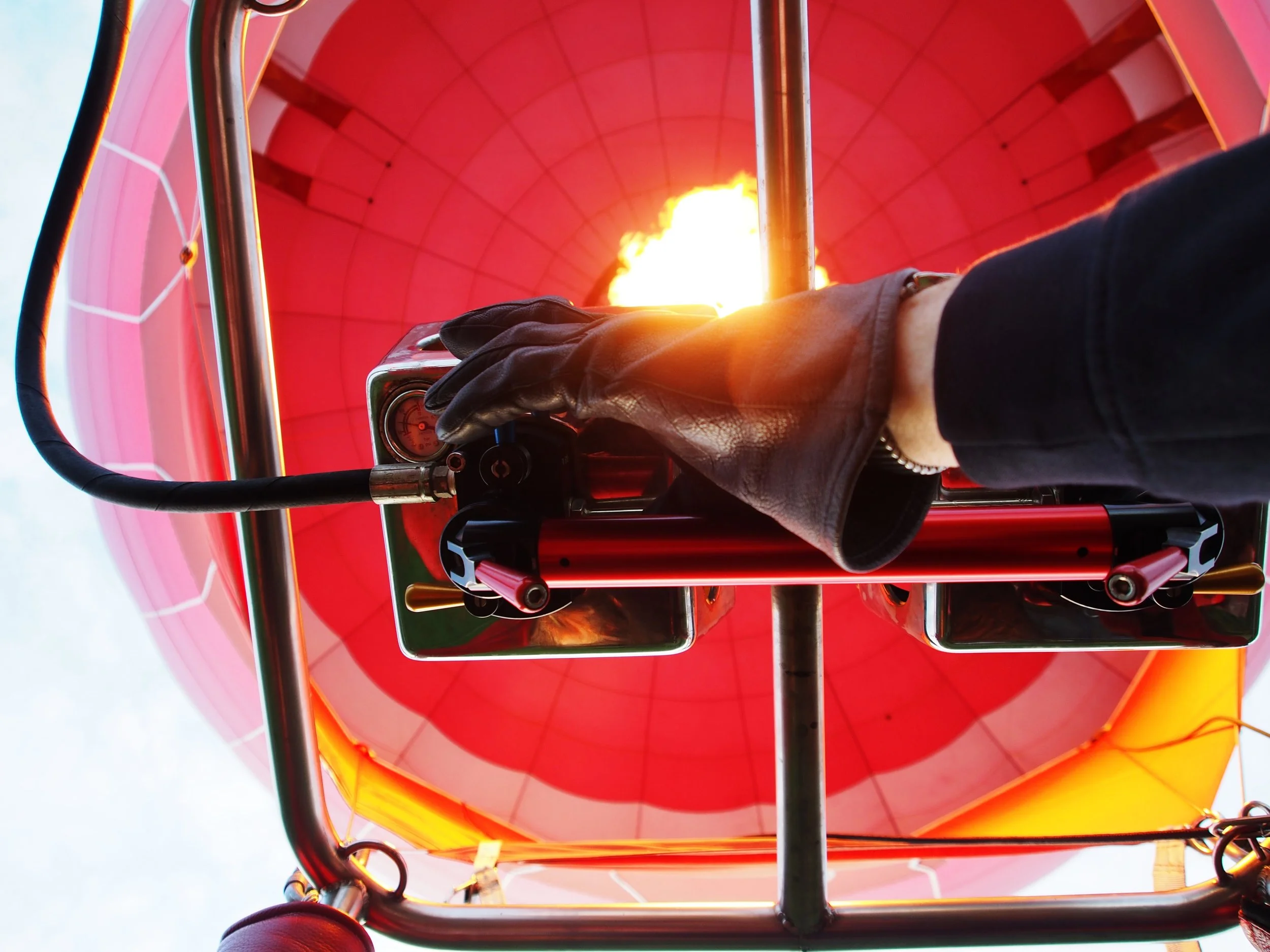 A hand on the burner of a hot air balloon
