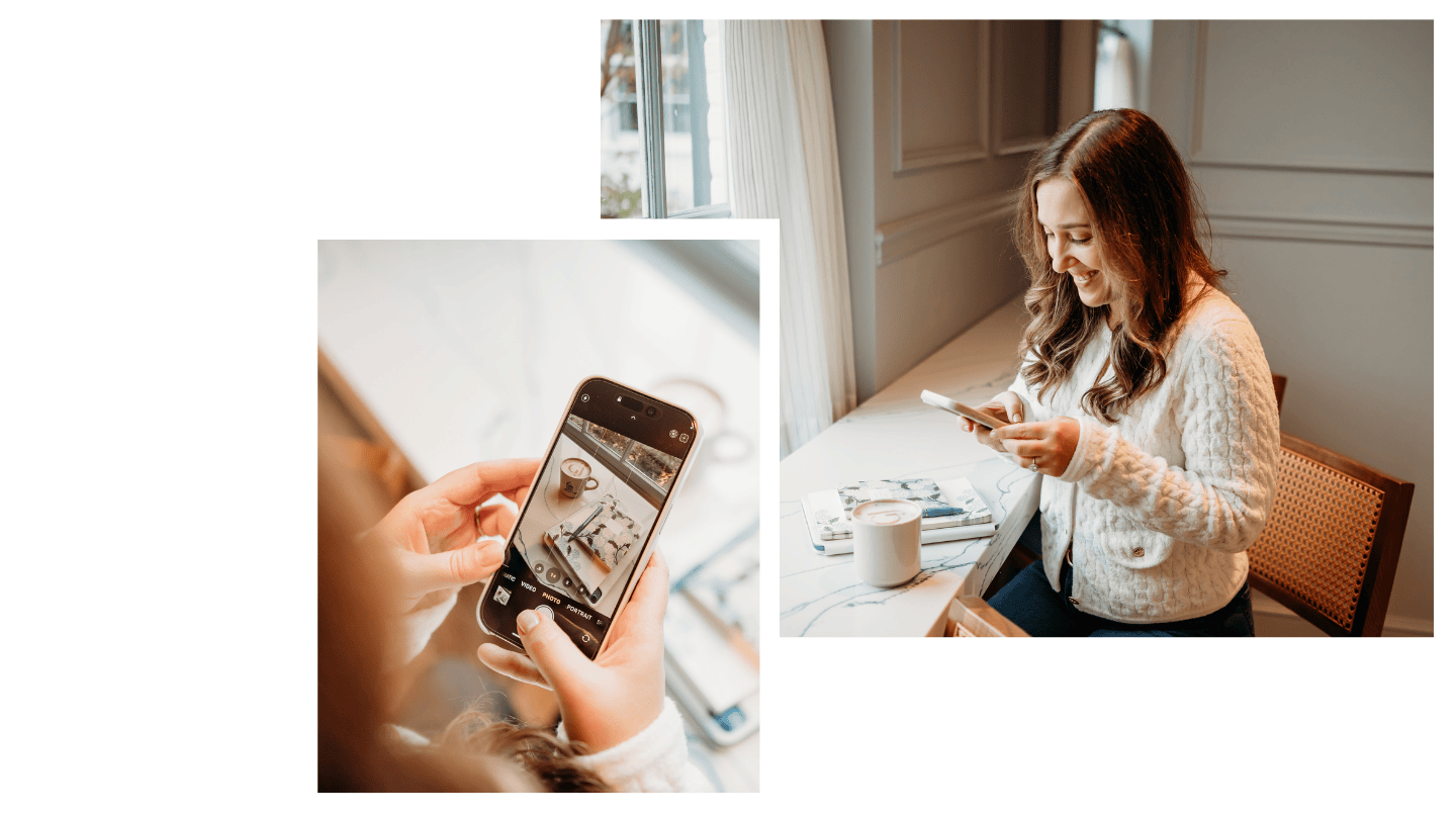 A woman with long brown hair, smiling and looking at her phone, is sitting at a white table near a window with natural light. On the table are a cup of coffee, magazines, and a notebook.