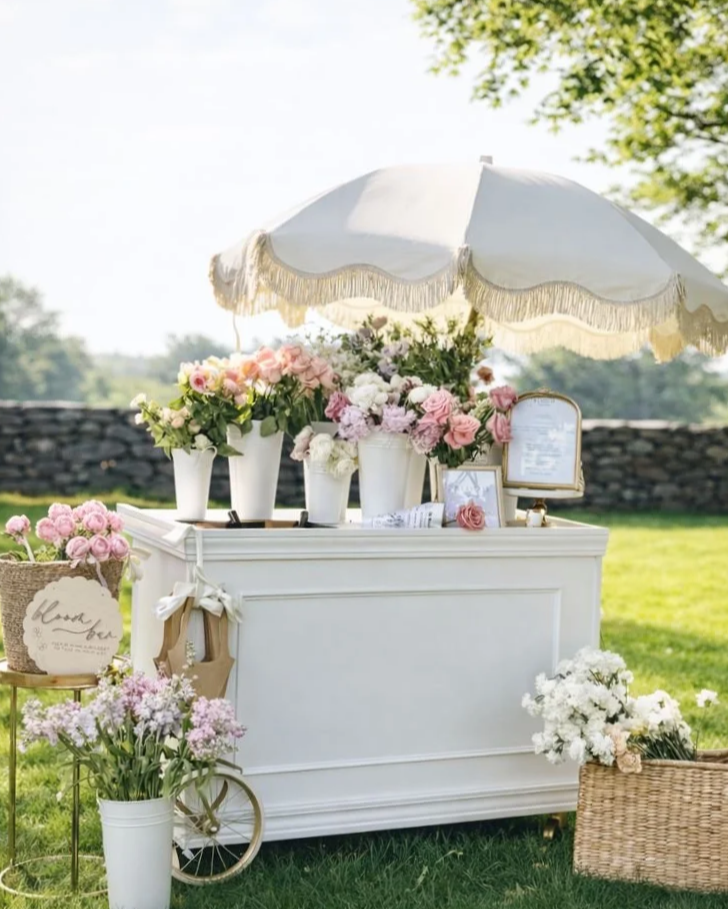 Luxury flower bar setup by Bloom Flower Bar featuring pastel florals and a European-inspired cart, designed for weddings and bridal showers in Rhode Island.