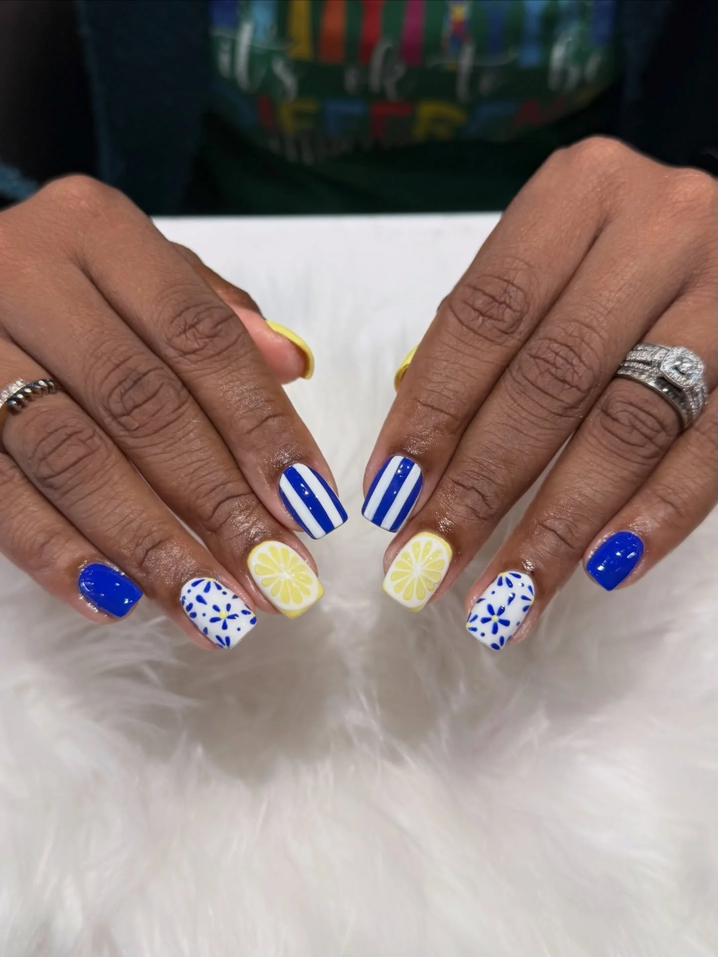 Postcard from the Amalfi Coast ✈️💙🍋 
Mediterranean blue, crisp white stripes, hand-painted florals, and juicy lemon slices. This set tastes like summer. 


  #Bellagionailsparaleigh #fyp #nails #naildesign 
 
BELLAGIO NAIL SPA
📍8845 Six Forks 