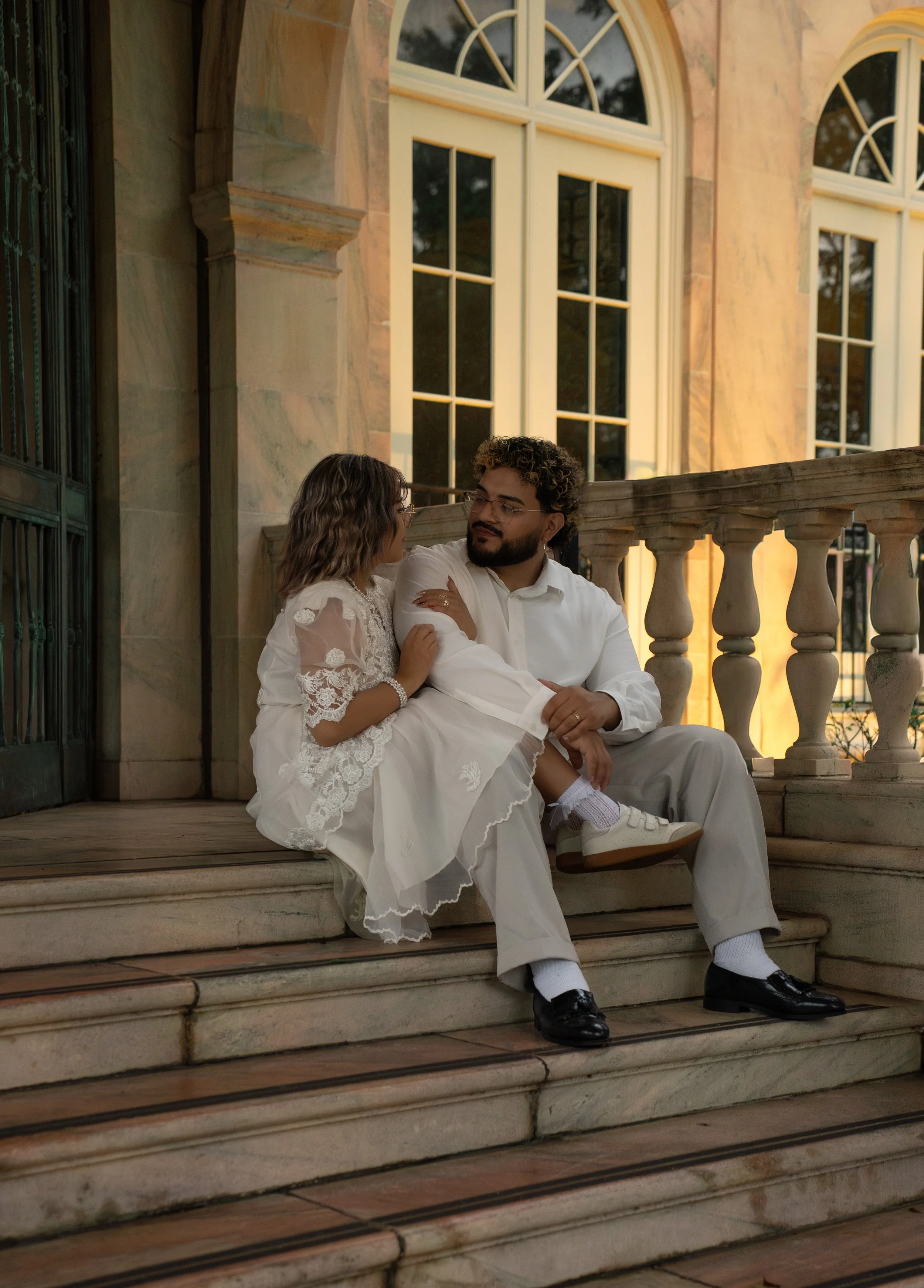 Couple seated together in an elegant historic interior during an editorial couples photography session at New College of Florida in Sarasota.