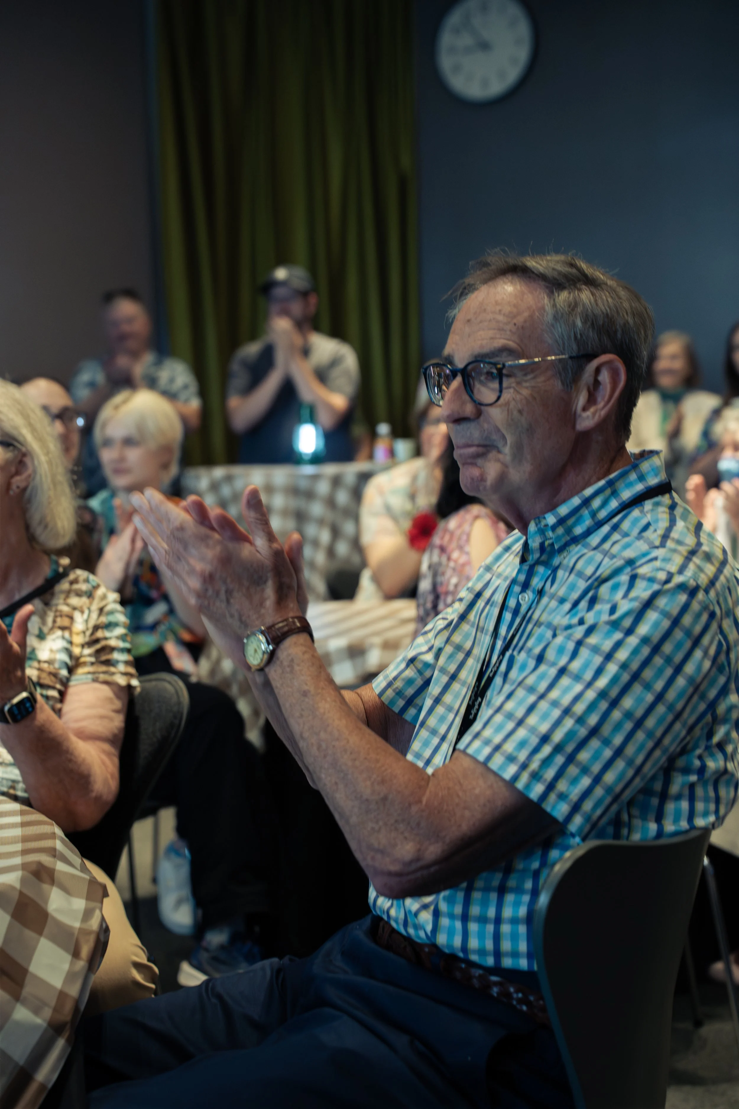 Guest applauding during a surprise retirement party photographed in Sarasota.