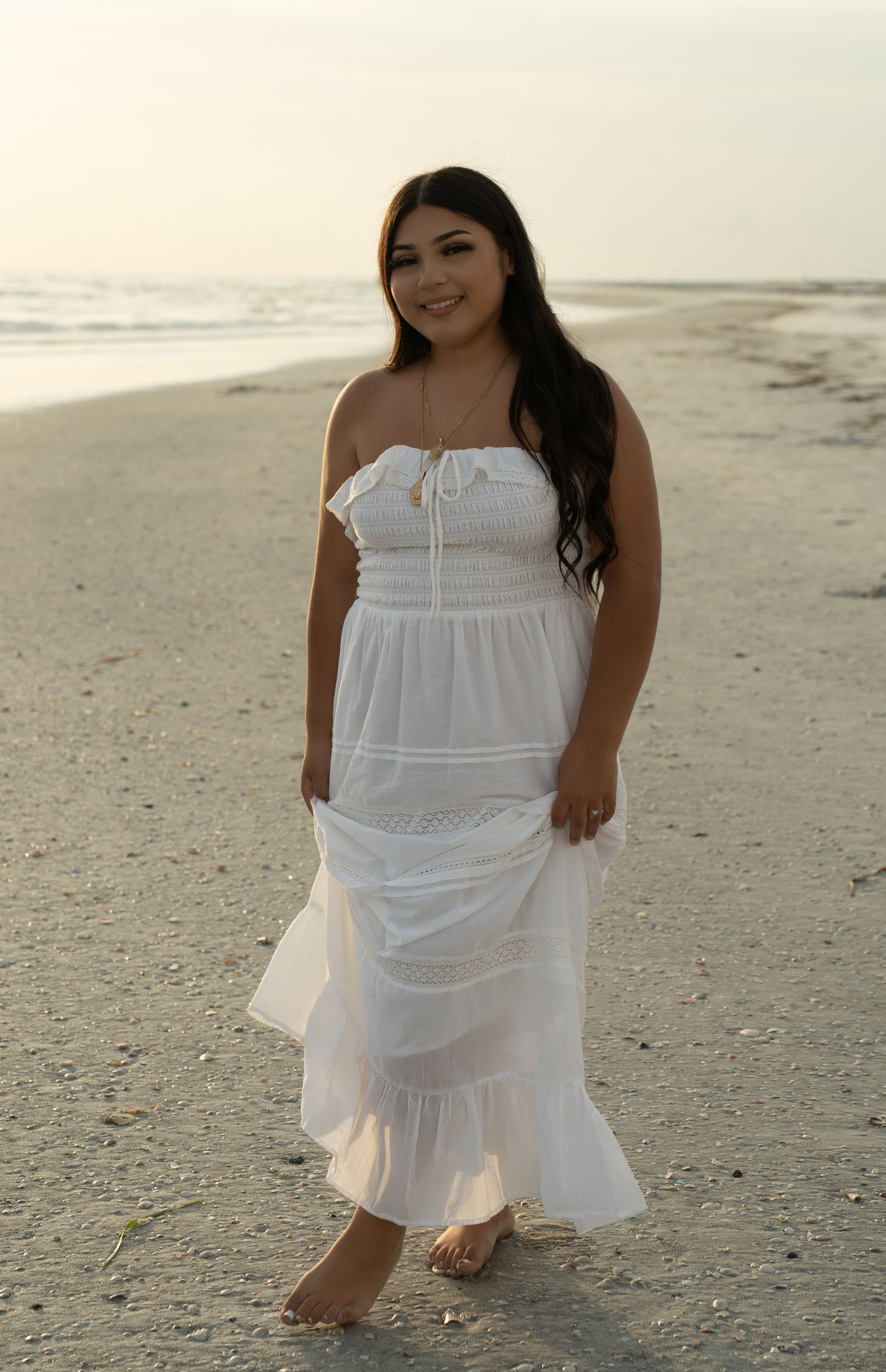 High school senior walking along Lido Key Beach in Sarasota