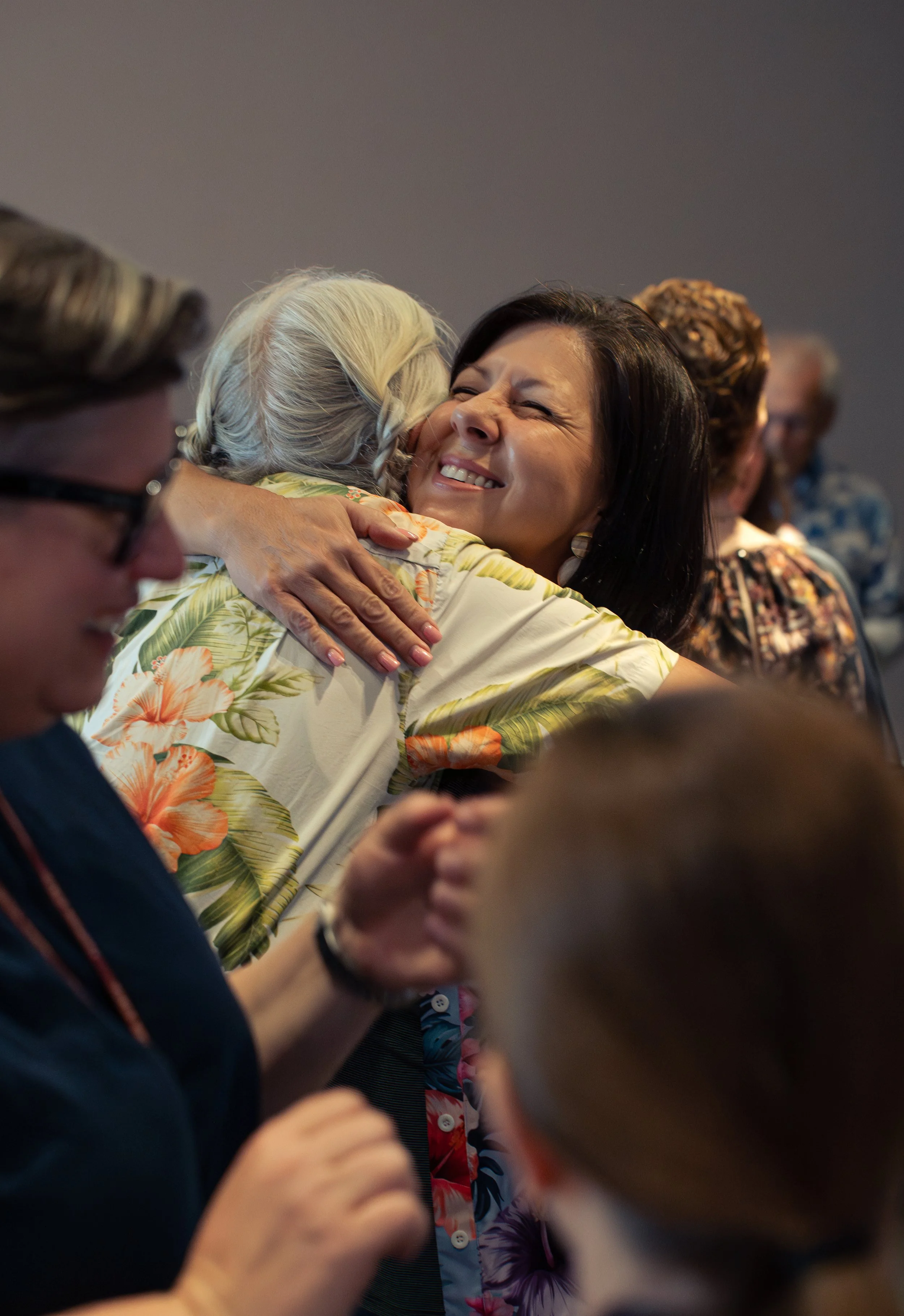 Emotional hug photographed during a retirement party in Sarasota, Florida.
