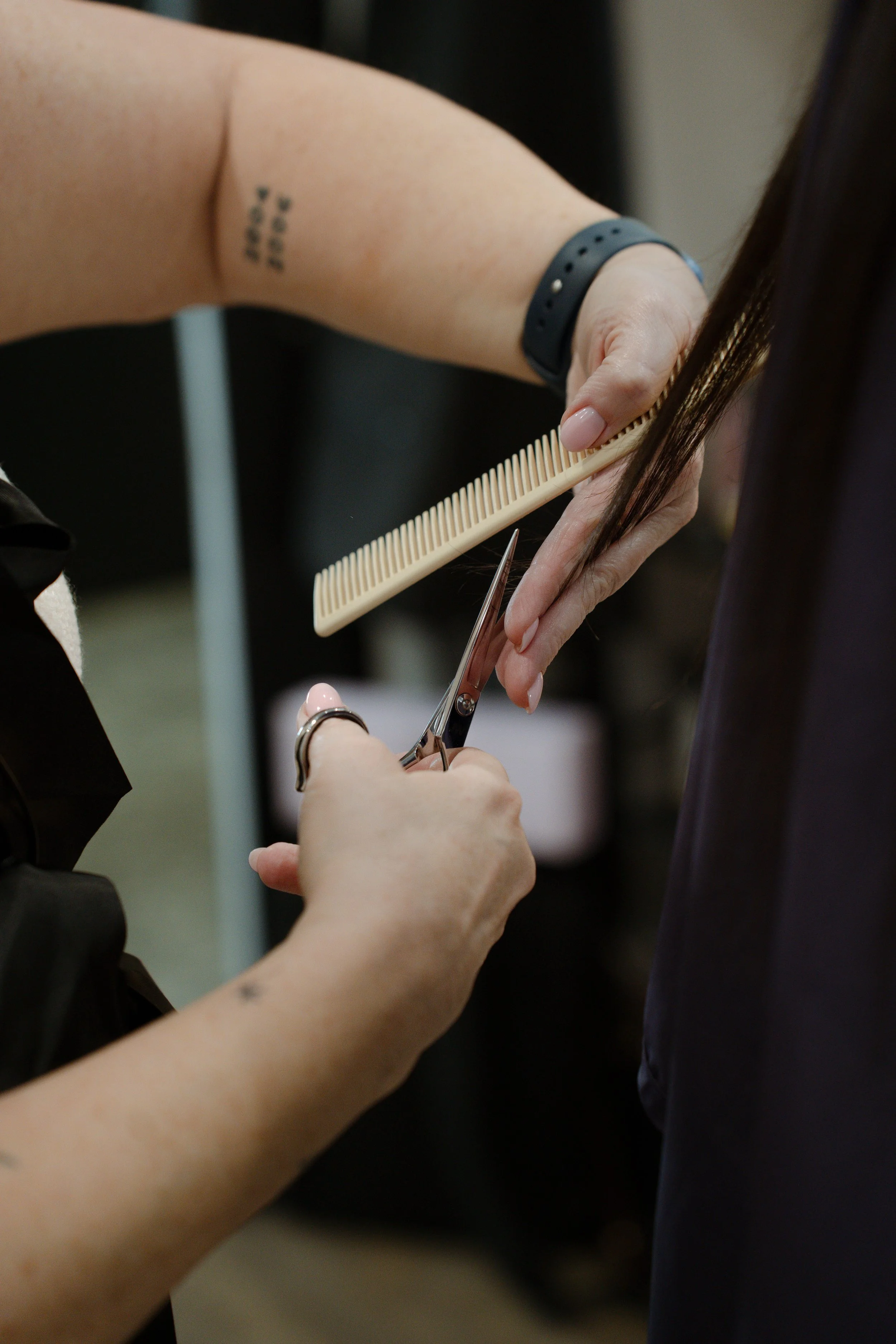 Close-up of a hairstylist cutting a client's hair during a Sarasota branding photography session.