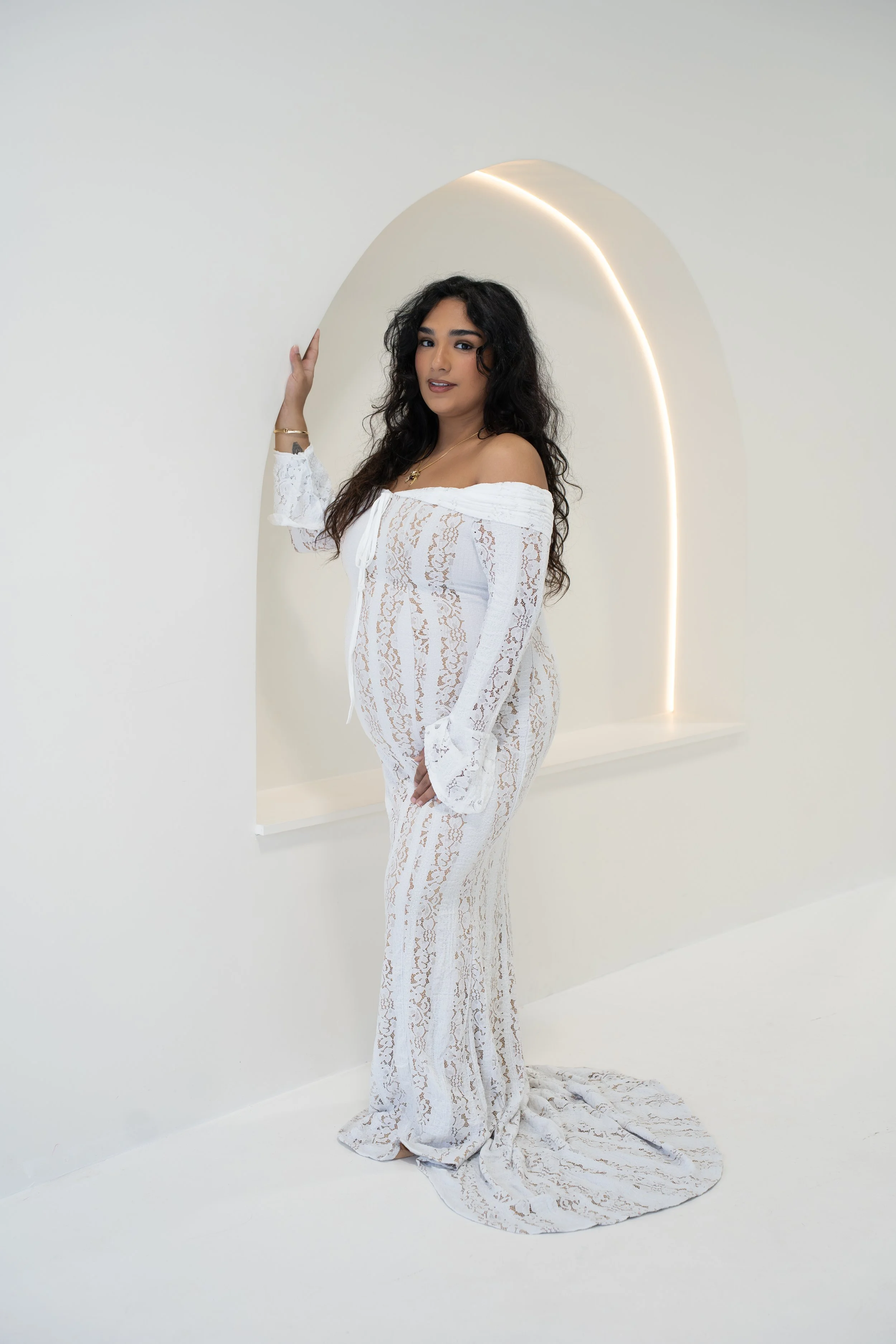Woman in a white dress posing during a creative studio portrait session in Sarasota, Florida