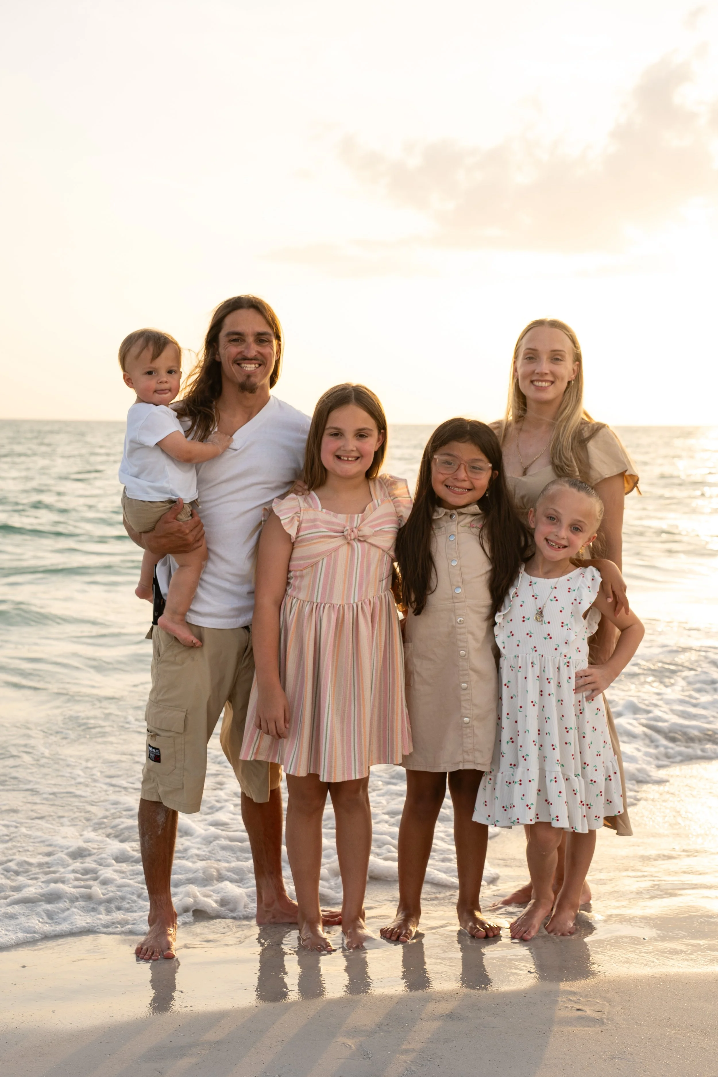 Family photographed together at Coquina Beach on Anna Maria Island