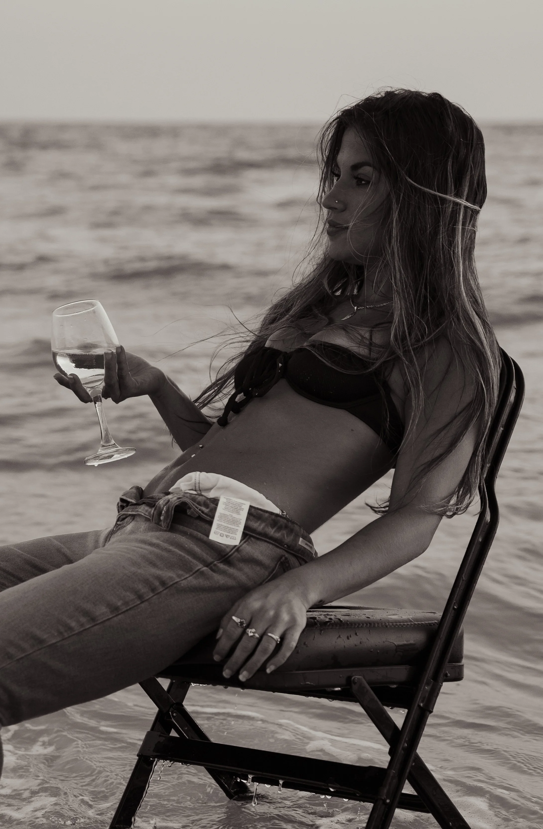 Black and white portrait of a woman relaxing in a chair on Lido Beach in Sarasota, Florida