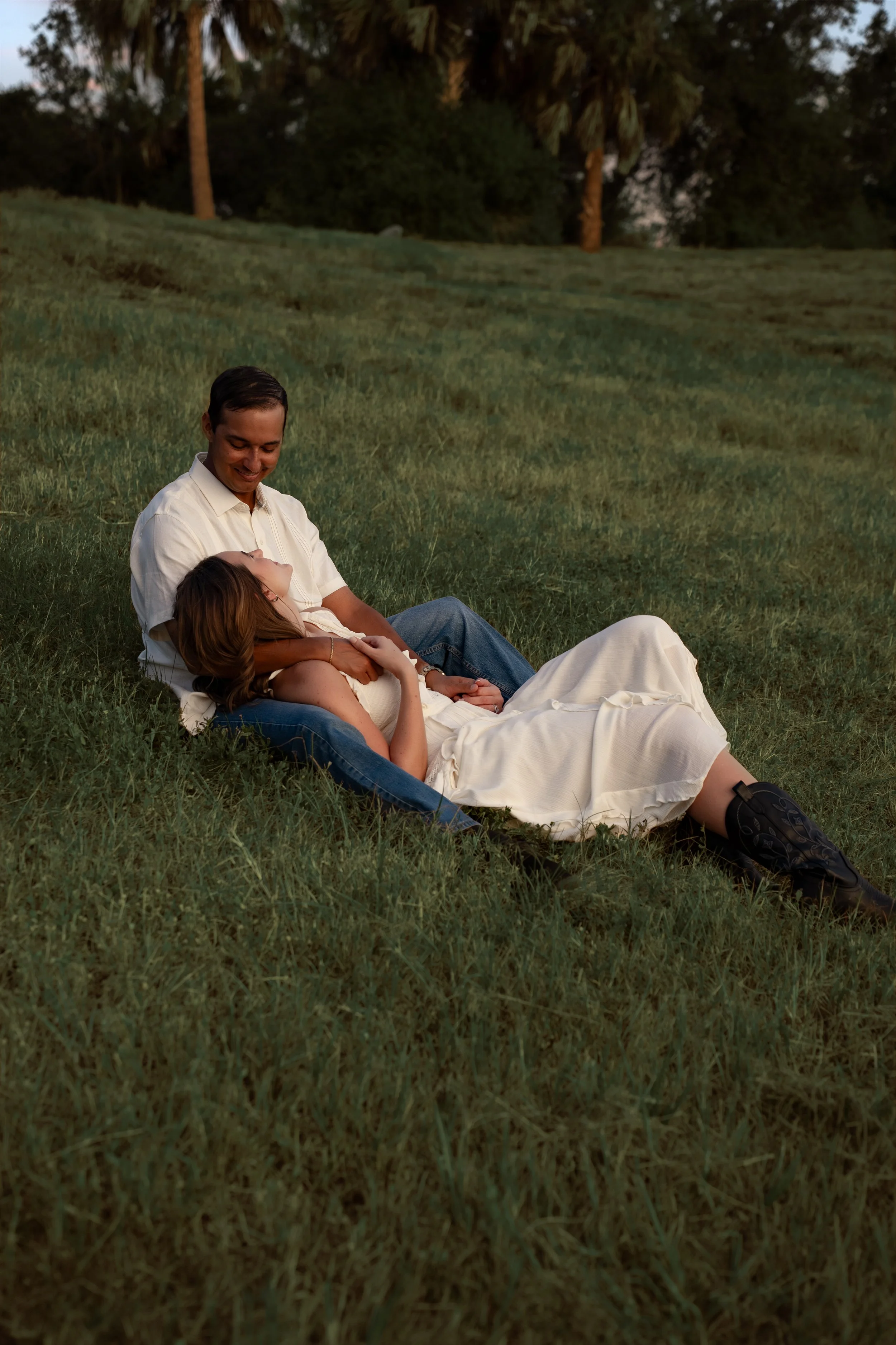 Couple relaxing together in the grass during a romantic portrait session at Celery Fields in Sarasota, Florida.