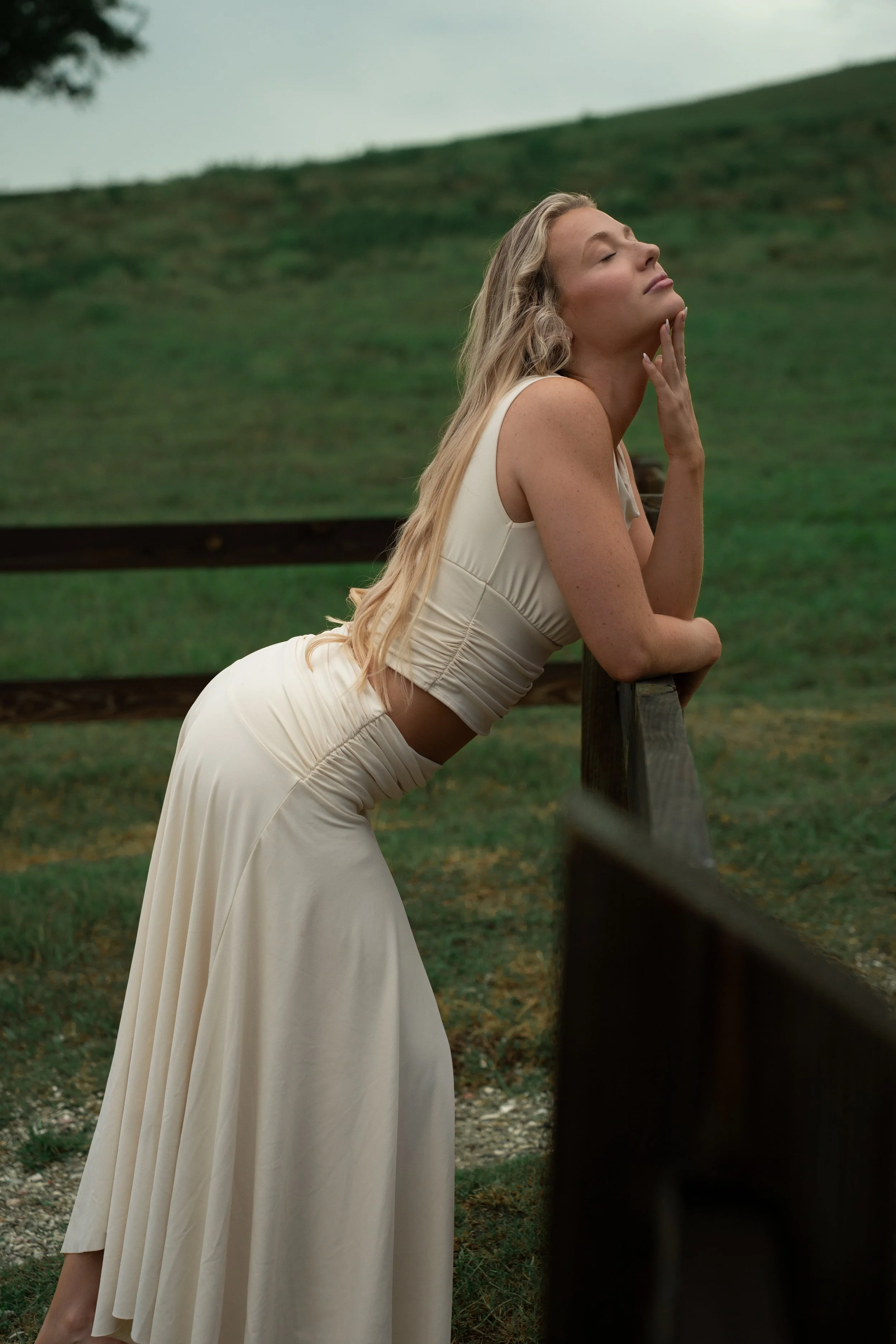 Woman posing against the green hills at Celery Fields in Sarasota, Florida