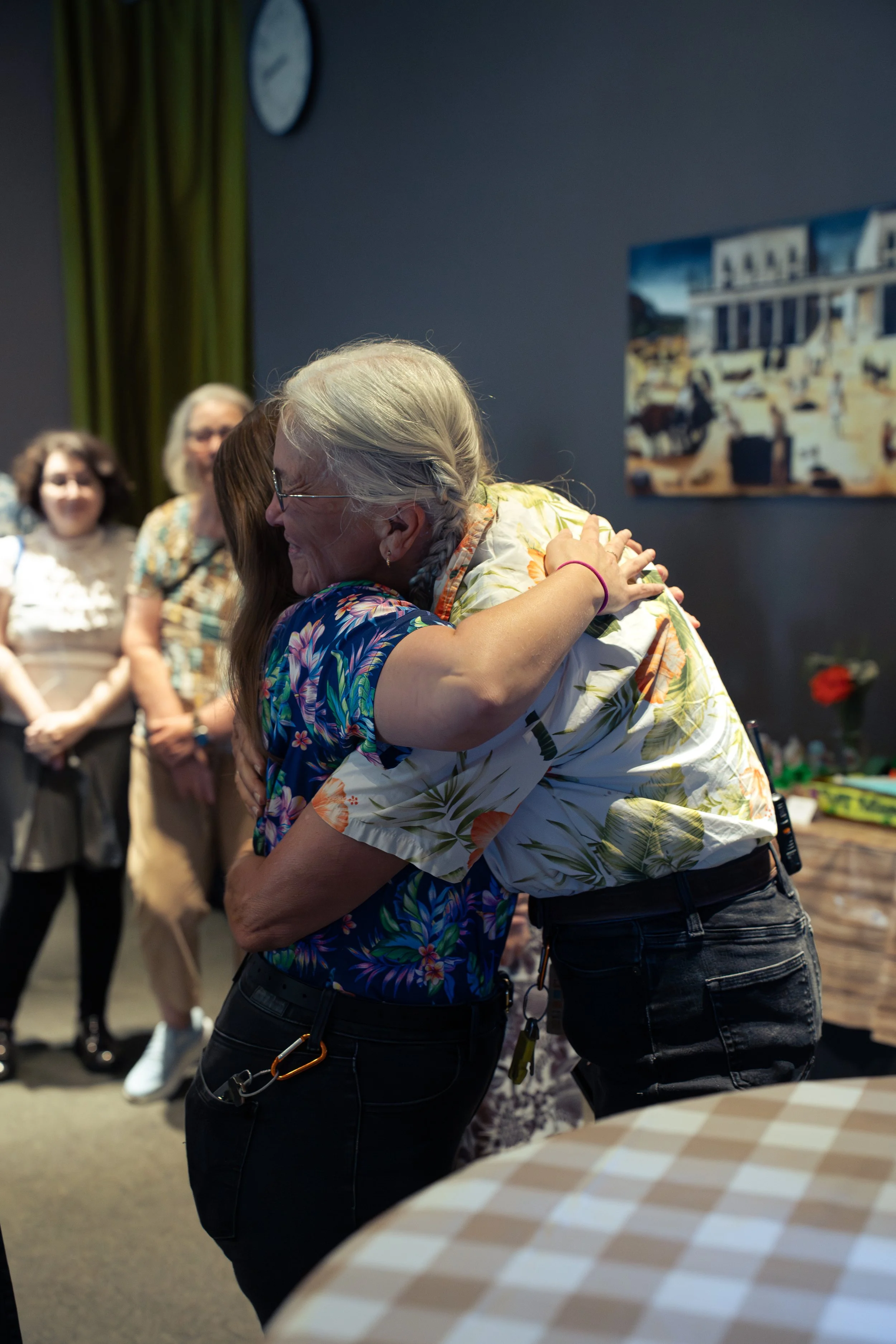 Candid moment between colleagues during a Sarasota retirement celebration.