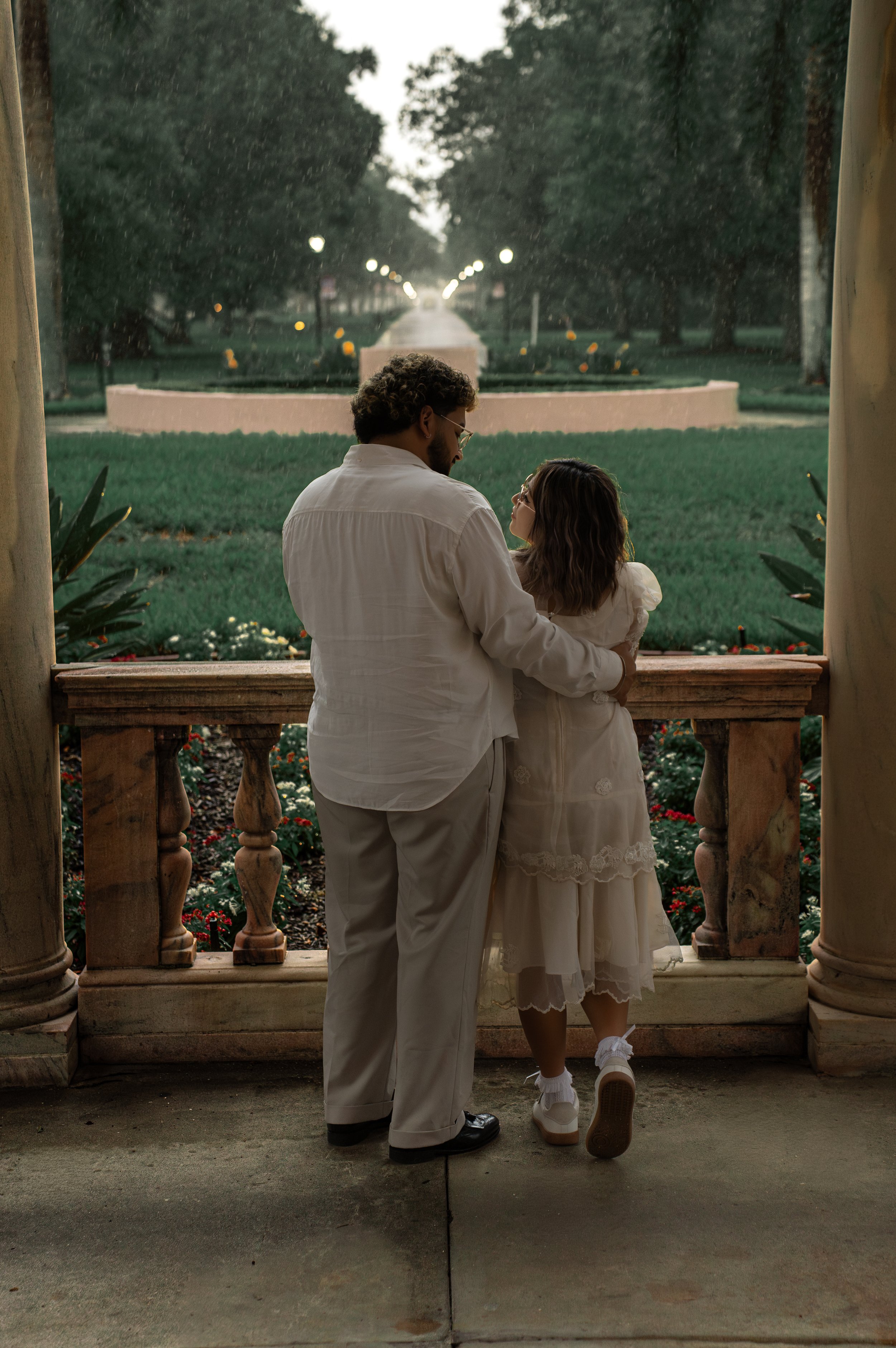 Couple sitting on historic architecture during a romantic editorial couples photoshoot at New College of Florida in Sarasota, Florida.