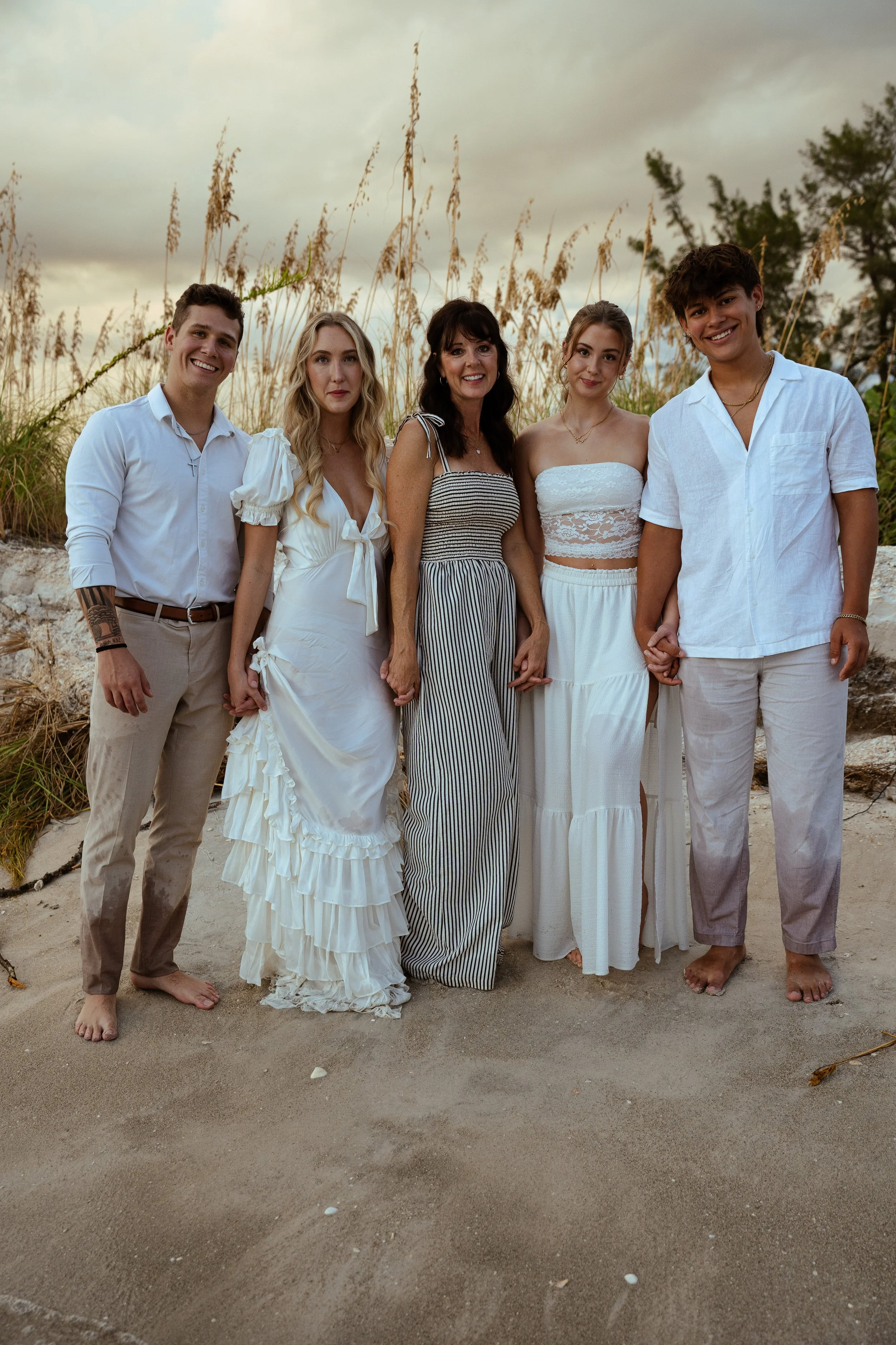 Family photographed together on Lido Key Beach in Sarasota