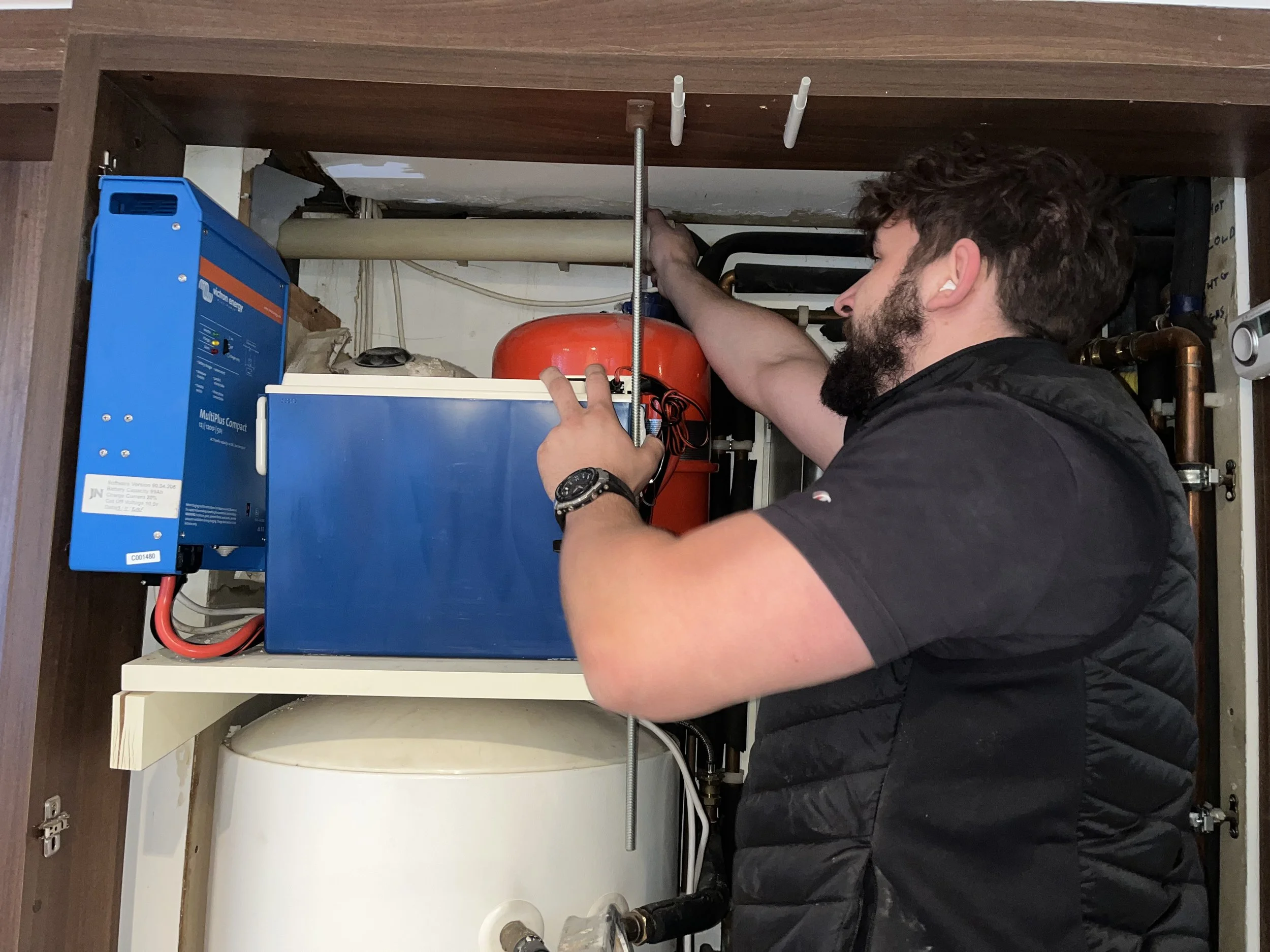 A gas safe engineer installing a flue for a boiler in london