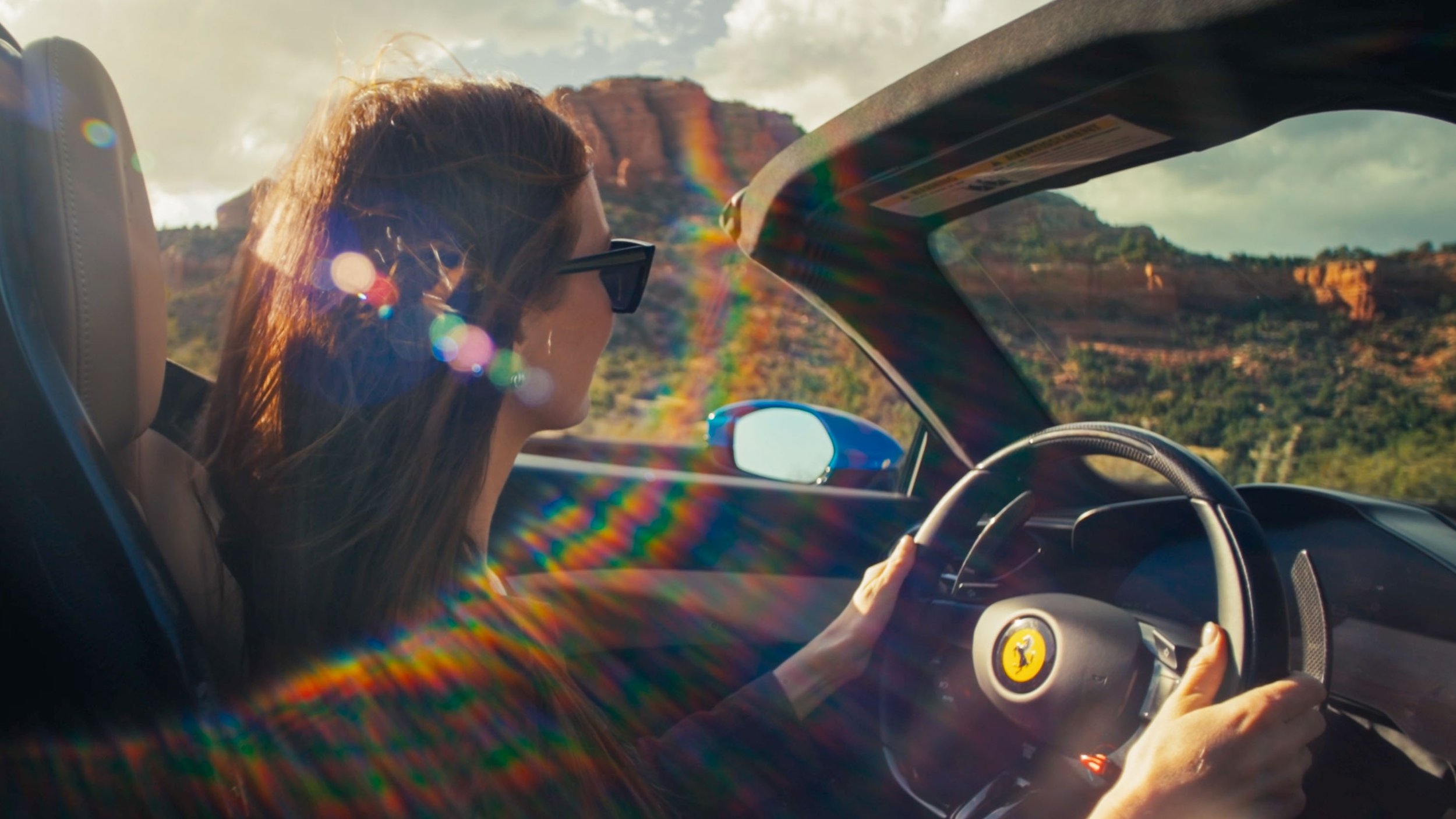 quinn-taplin-ferrari-postcards-woman-driving-sunglasses.jpg