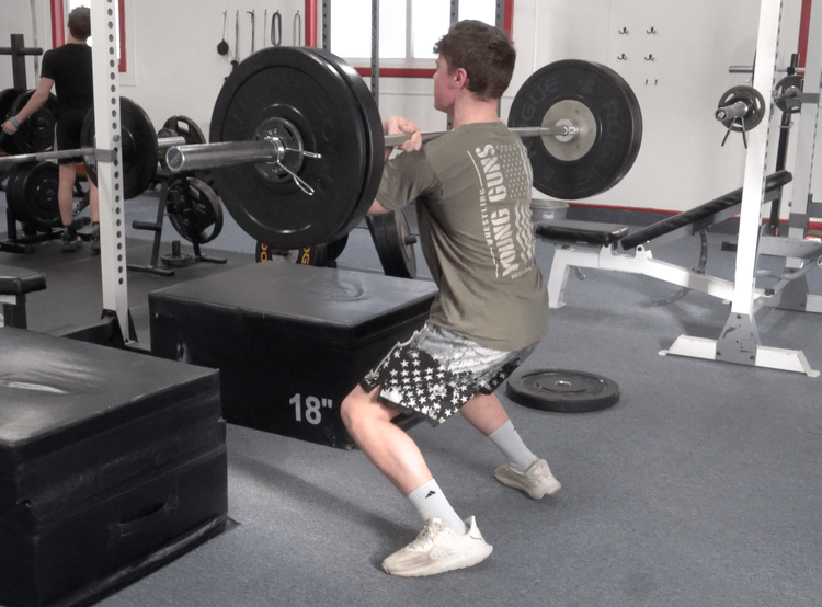 Athlete power cleaning